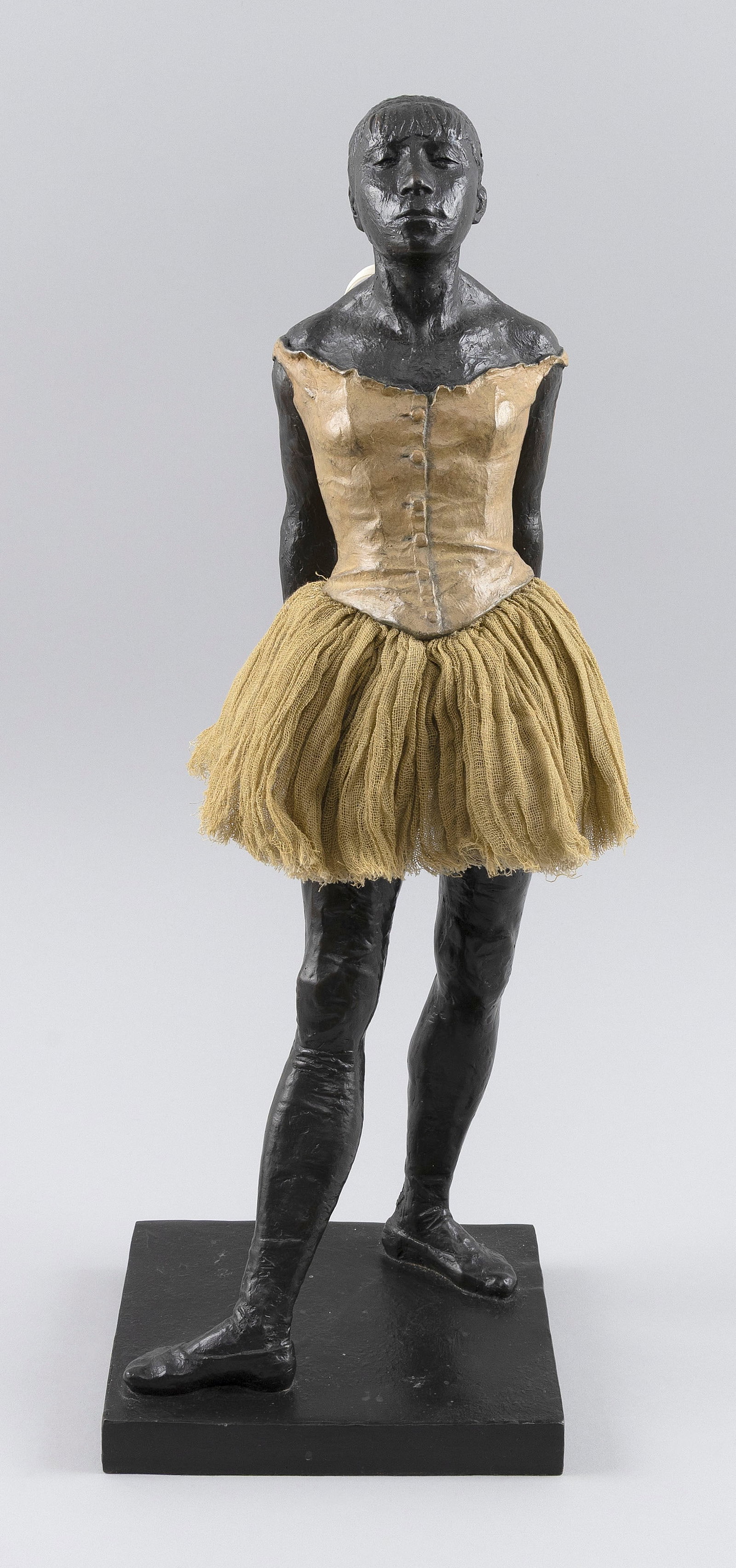 AFTER EDGAR DEGAS (Late 20th Century,), Copy of "La Petite Danseuse de Quatorze Ans"., Bronze with: AFTER EDGAR DEGAS Late 20th Century Copy of "La Petite Danseuse de Quatorze Ans". Marked for the Museum of Fine Arts, Boston. Bronze with cotton skirt, height 20.5". Base 6.5" x 7.25".