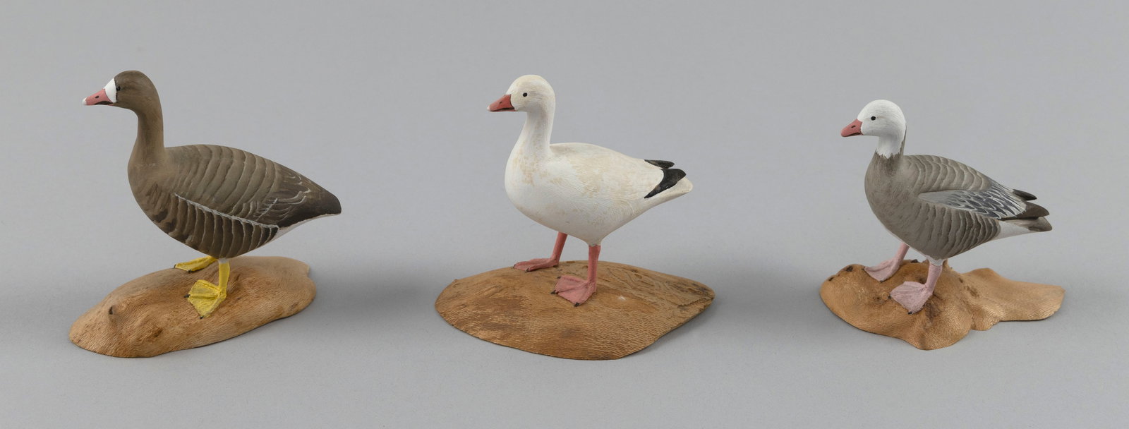THREE HAROLD GIBBS MINIATURE GEESE CARVINGS Barrington, Rhode Island, 1866-1970 Heights from 3" to: THREE HAROLD GIBBS MINIATURE GEESE CARVINGS Barrington, Rhode Island, 1866-1970 A blue goose, a specklebelly goose and snow goose, all mounted on driftwood bases. Circa 1960. Heights from 3" to 3.5".