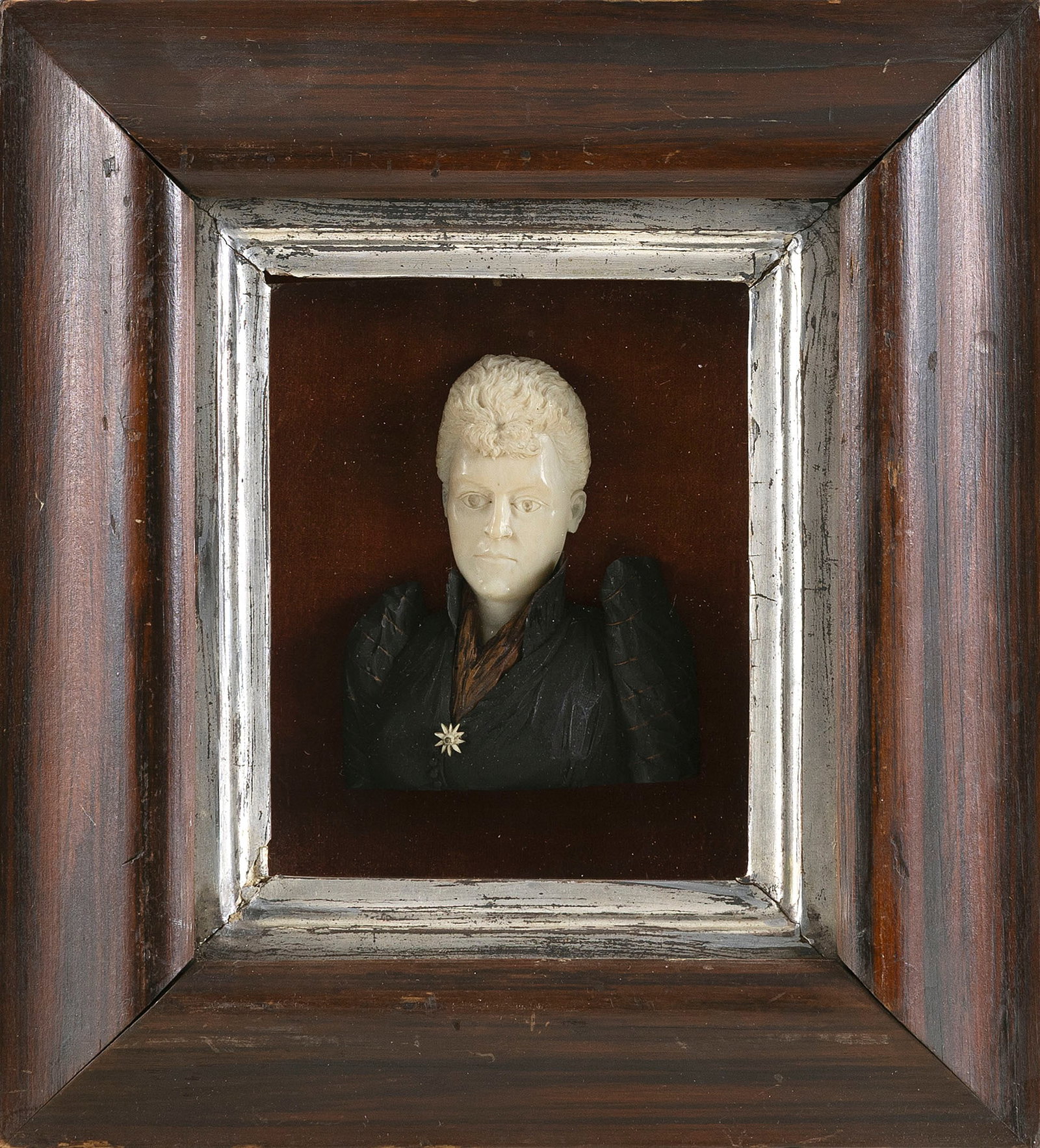 CARVED IVORY BUST PORTRAIT OF A WOMAN First Half of the 19th Century Framed 11" x 9.75".: CARVED IVORY BUST PORTRAIT OF A WOMAN First Half of the 19th Century With black fabric dress. Illegible provenance inscribed on backboard. Framed 11" x 9.75". Provenance: The Estate of Paul and Diane 