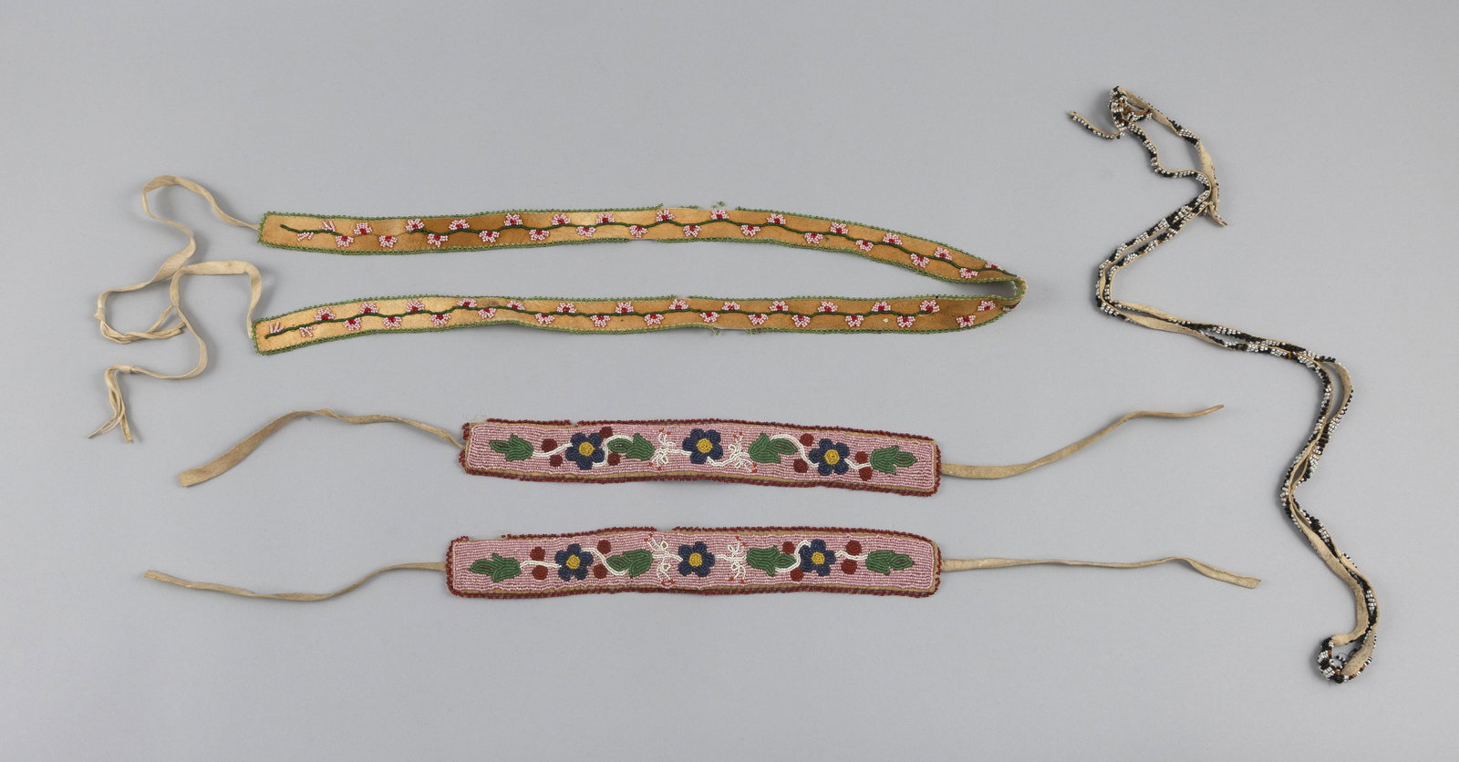 FIVE PIECES OF NATIVE AMERICAN BEADWORK Early 20th Century Lengths from 13" to 55". (1 of 2)