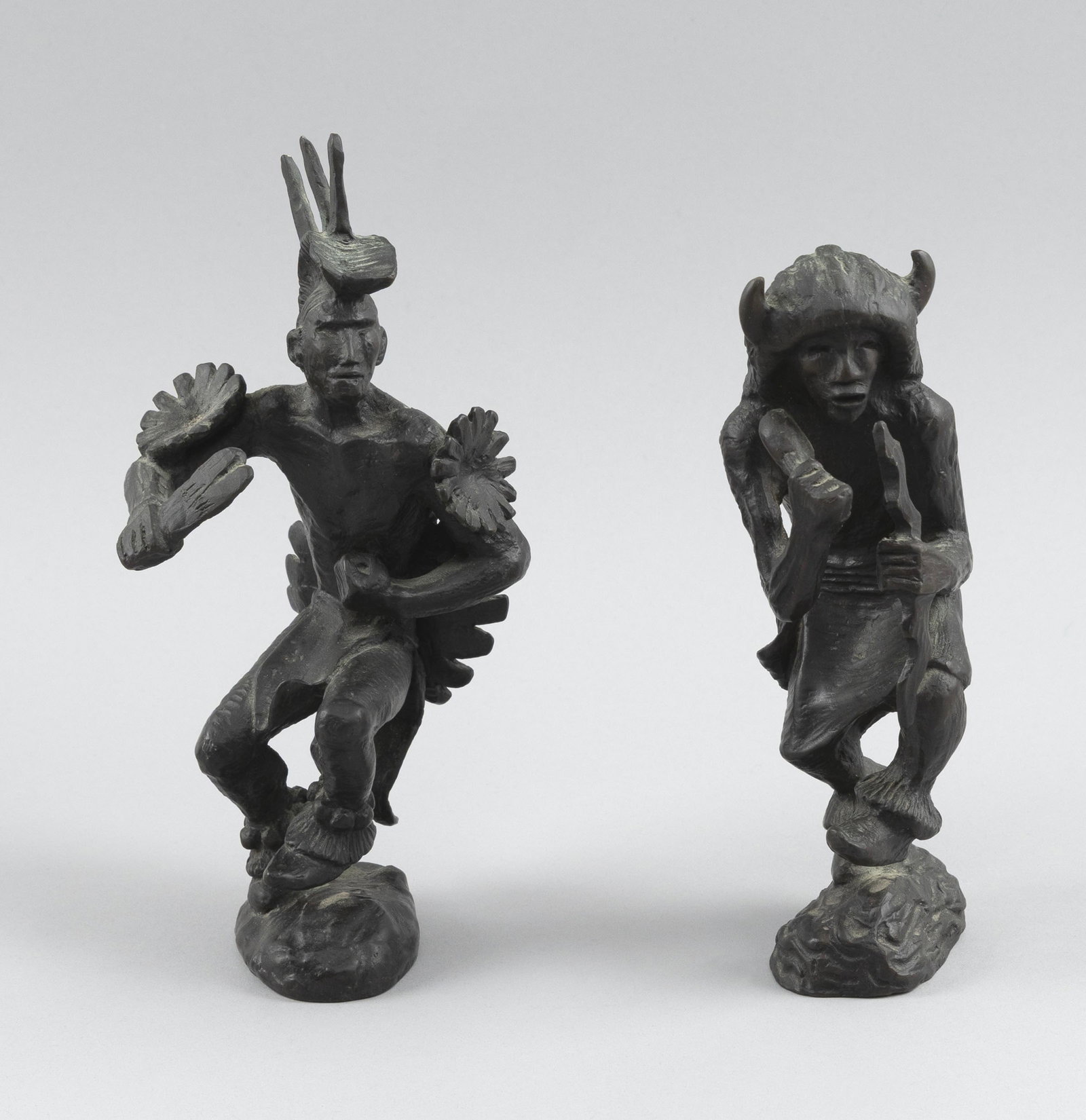ALLAN HOUSER (Chiricahua Apache, 1914-1994), Two Native American dancers:, Bronzes, heights approx.: ALLAN HOUSER Chiricahua Apache, 1914-1994 Two Native American dancers: 1) Buffalo dancer. Stamped "Houser", dated "'67", numbered 38/129, and marked "nm" in a circle on base. 2) Dancer with spiked hea