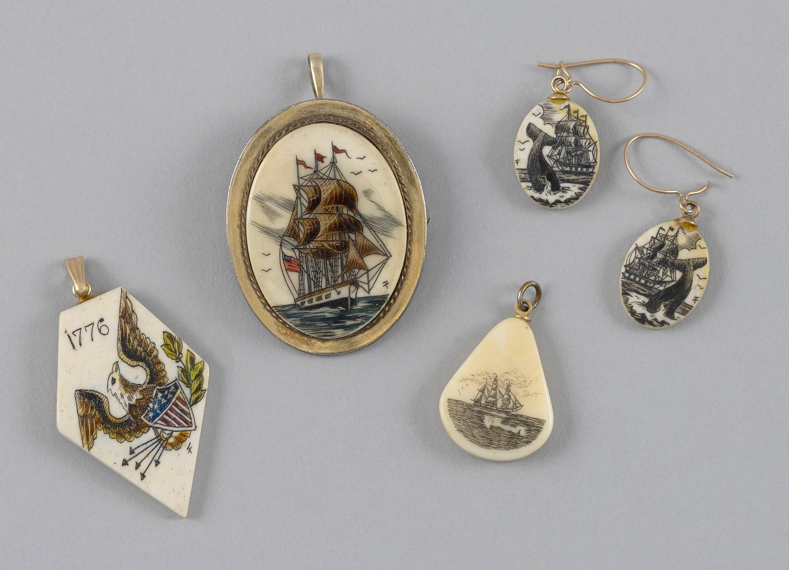 * FIVE PIECES OF ENGRAVED WHALE IVORY JEWELRY 20th Century Larger pendant 1.25" x 1". (1 of 2)