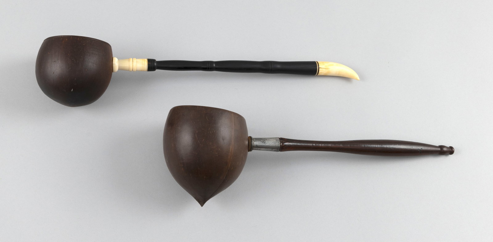 TWO SAILOR-MADE COCONUT SHELL DIPPERS 19th Century Lengths 15" and 16.5". (1 of 4)