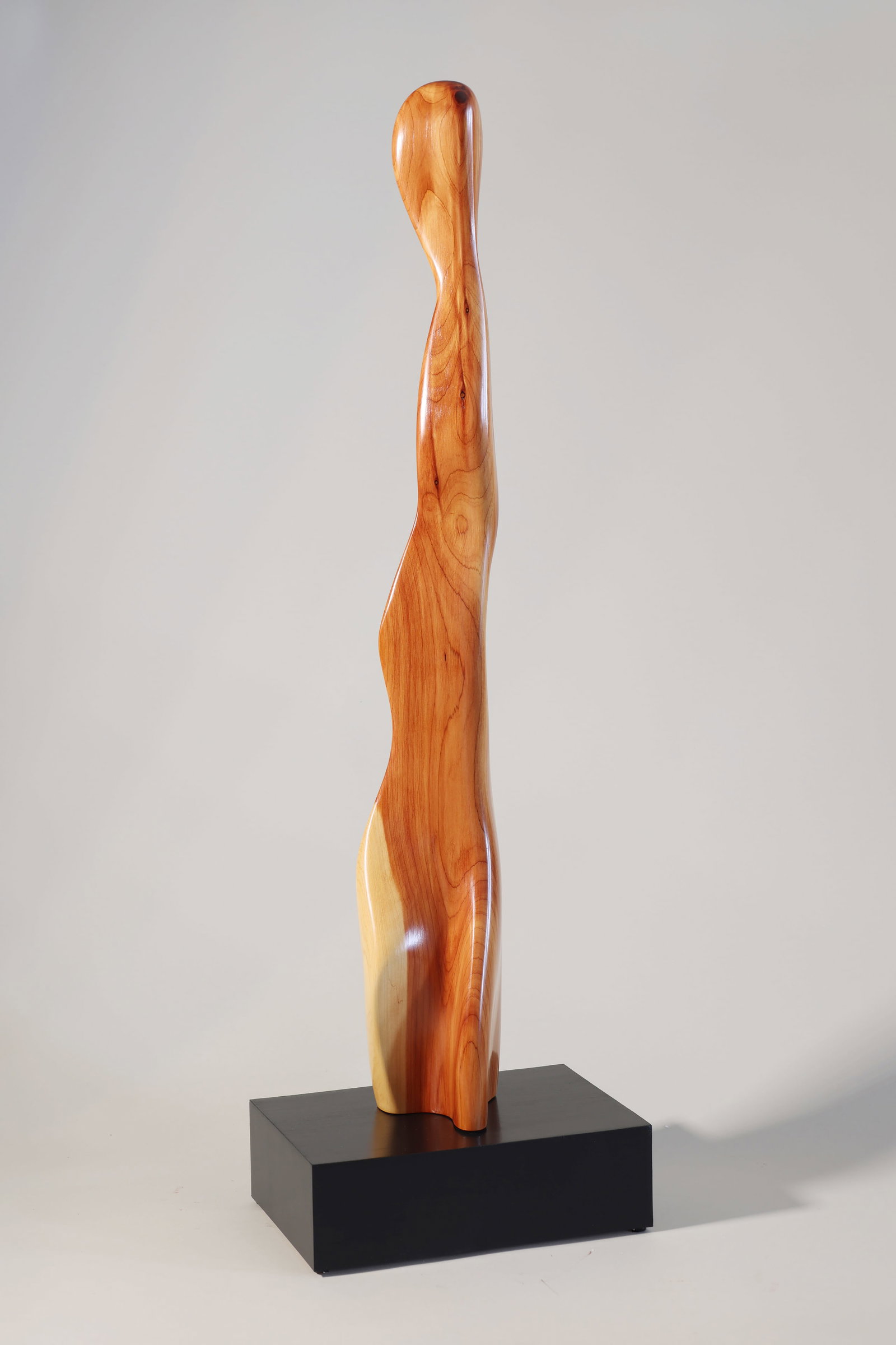 ROBERT SCUTT (Connecticut/Massachusetts, Contemporary), Graceful Lady., Red cedar on black base, 34": ROBERT SCUTT Connecticut/Massachusetts, Contemporary Graceful Lady. Red cedar on black base, 34" x 10" x 7".
