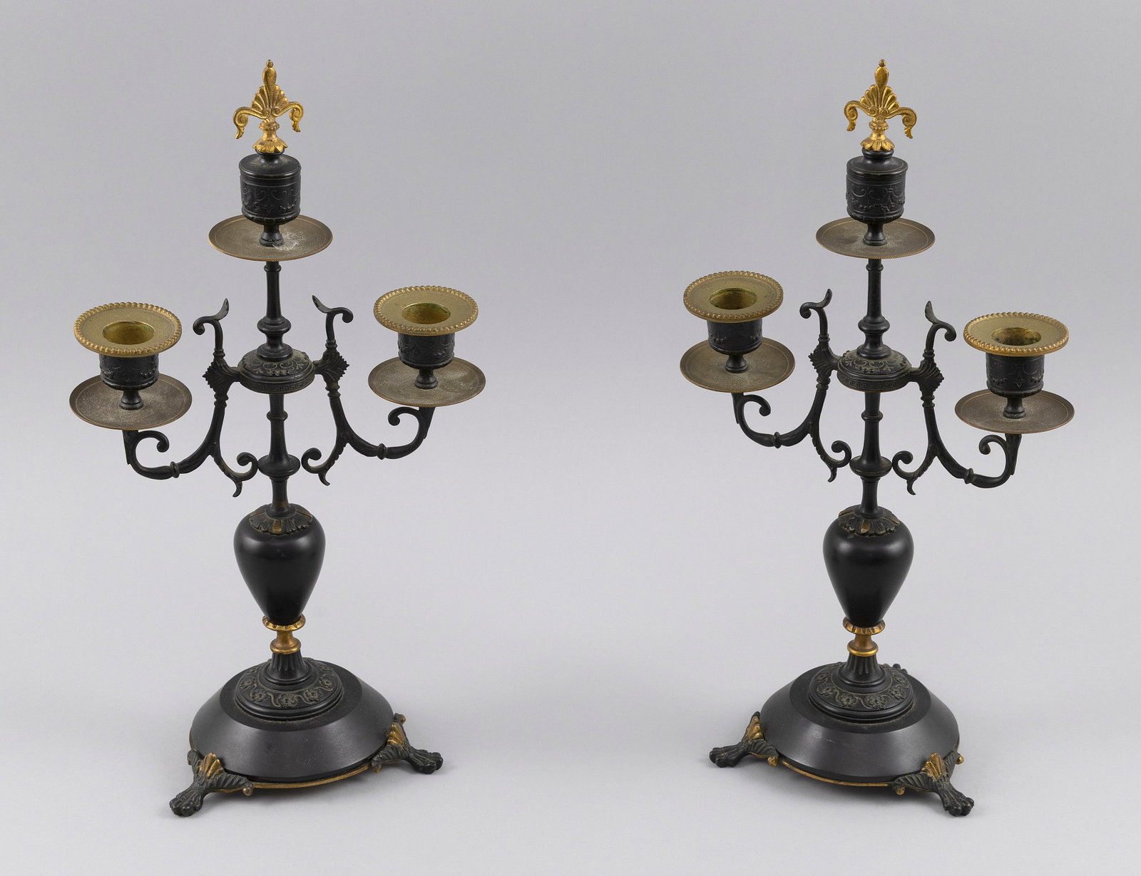 PAIR OF GRAND TOUR TWO-TONE BRONZE TRIPLE CANDLEHOLDERS Late 19th Century Heights 14".: PAIR OF GRAND TOUR TWO-TONE BRONZE TRIPLE CANDLEHOLDERS Late 19th Century Pair of finials function as the central cups. Heights 14".