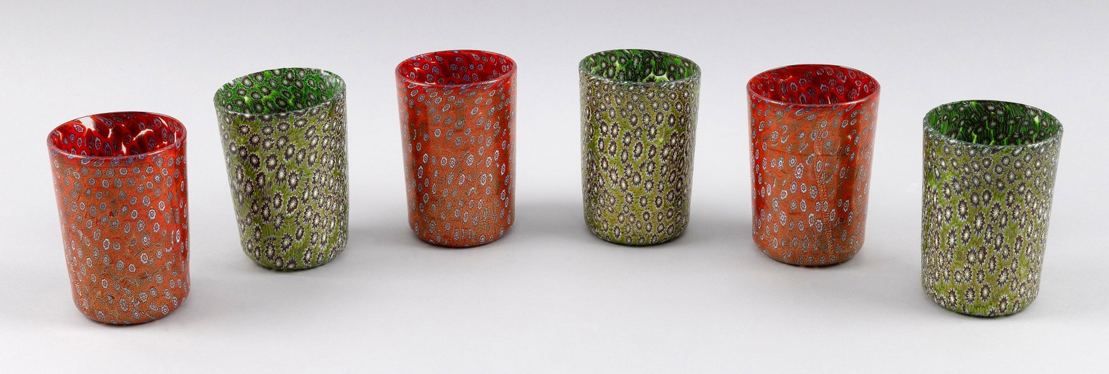 SET OF SIX MURANO GLASS TUMBLERS Italy, 20th Century Heights 4". Diameters 2.75".: SET OF SIX MURANO GLASS TUMBLERS Italy, 20th Century Three red and three green, all with millefiori decoration. Heights 4". Diameters 2.75".