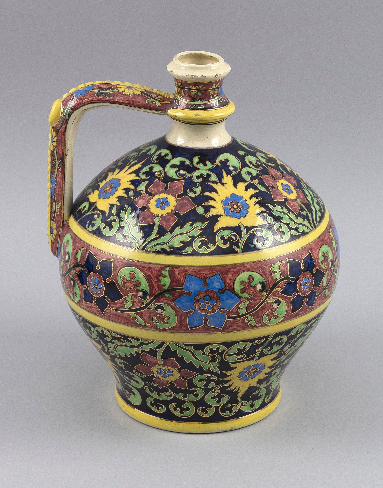 ZSOLNAY PORCELAIN EWER Hungary, Late 19th Century Height 10.5".: ZSOLNAY PORCELAIN EWER Hungary, Late 19th Century Gilt and polychrome enamel floral and foliate banded decoration. Height 10.5".