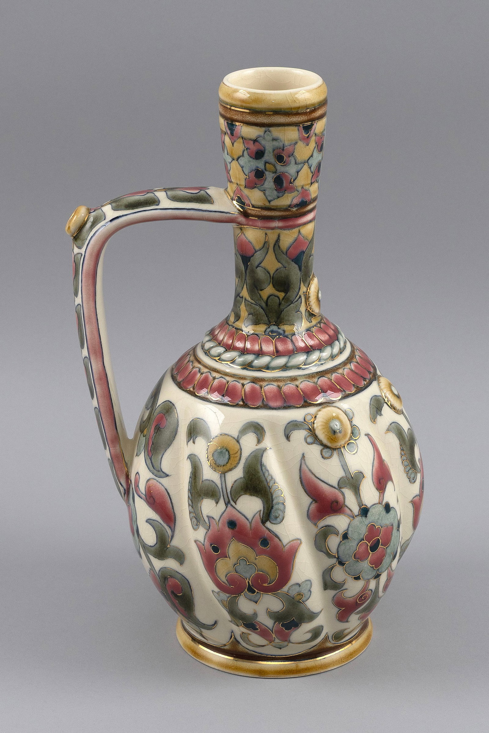 ZSOLNAY PORCELAIN EWER Hungary, Late 19th Century Height 11.5".: ZSOLNAY PORCELAIN EWER Hungary, Late 19th Century Gilt and polychrome enamel floral decoration against an ivory ground. Height 11.5".