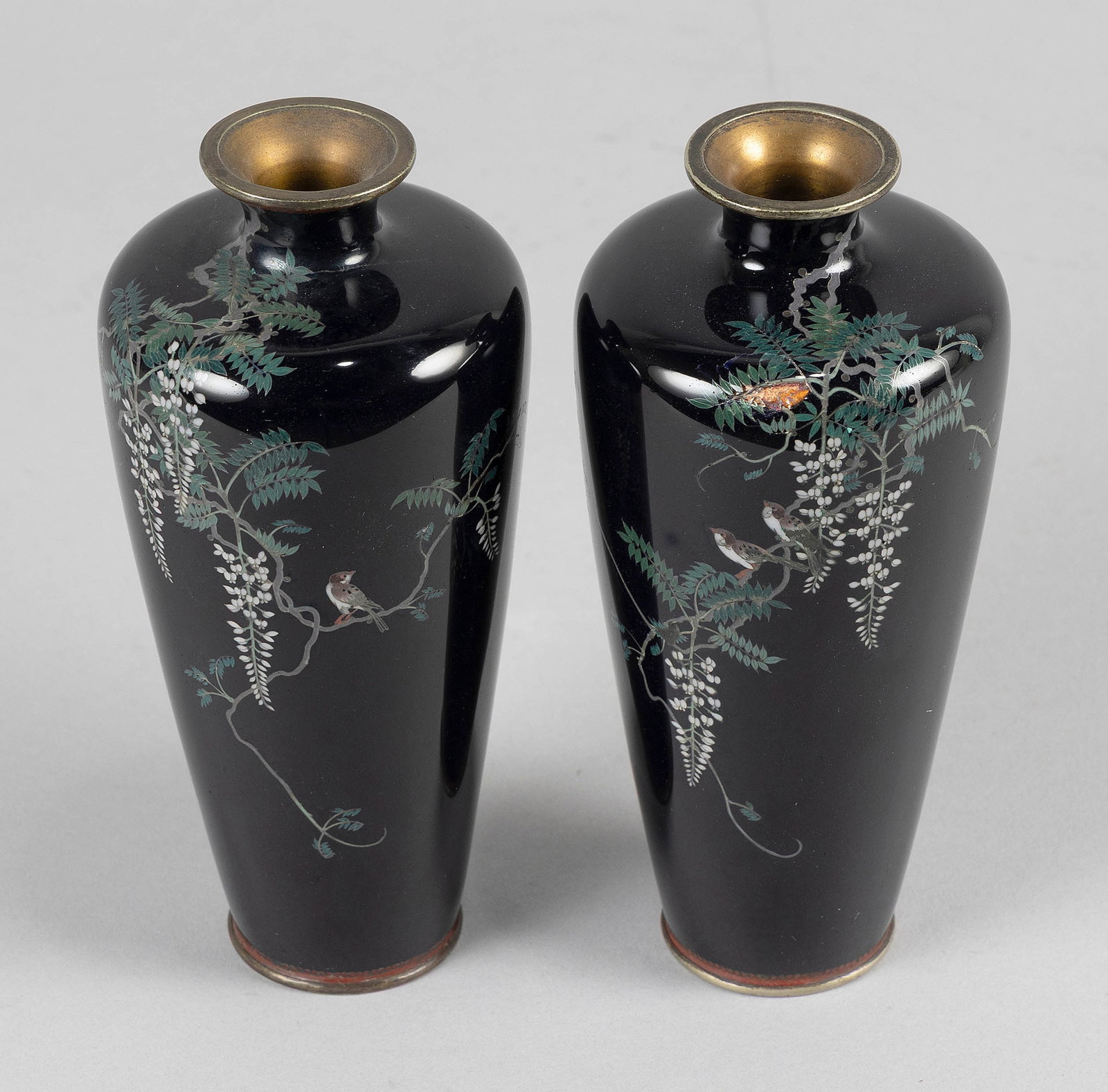 PAIR OF JAPANESE CLOISONNE ENAMEL CABINET VASES Late Meiji Period (Turn of the 20th Century) Heights: PAIR OF JAPANESE CLOISONNE ENAMEL CABINET VASES Late Meiji Period (Turn of the 20th Century) Decoration of birds on wisteria branches against a dark blue ground. One with visible but untraced mark on 