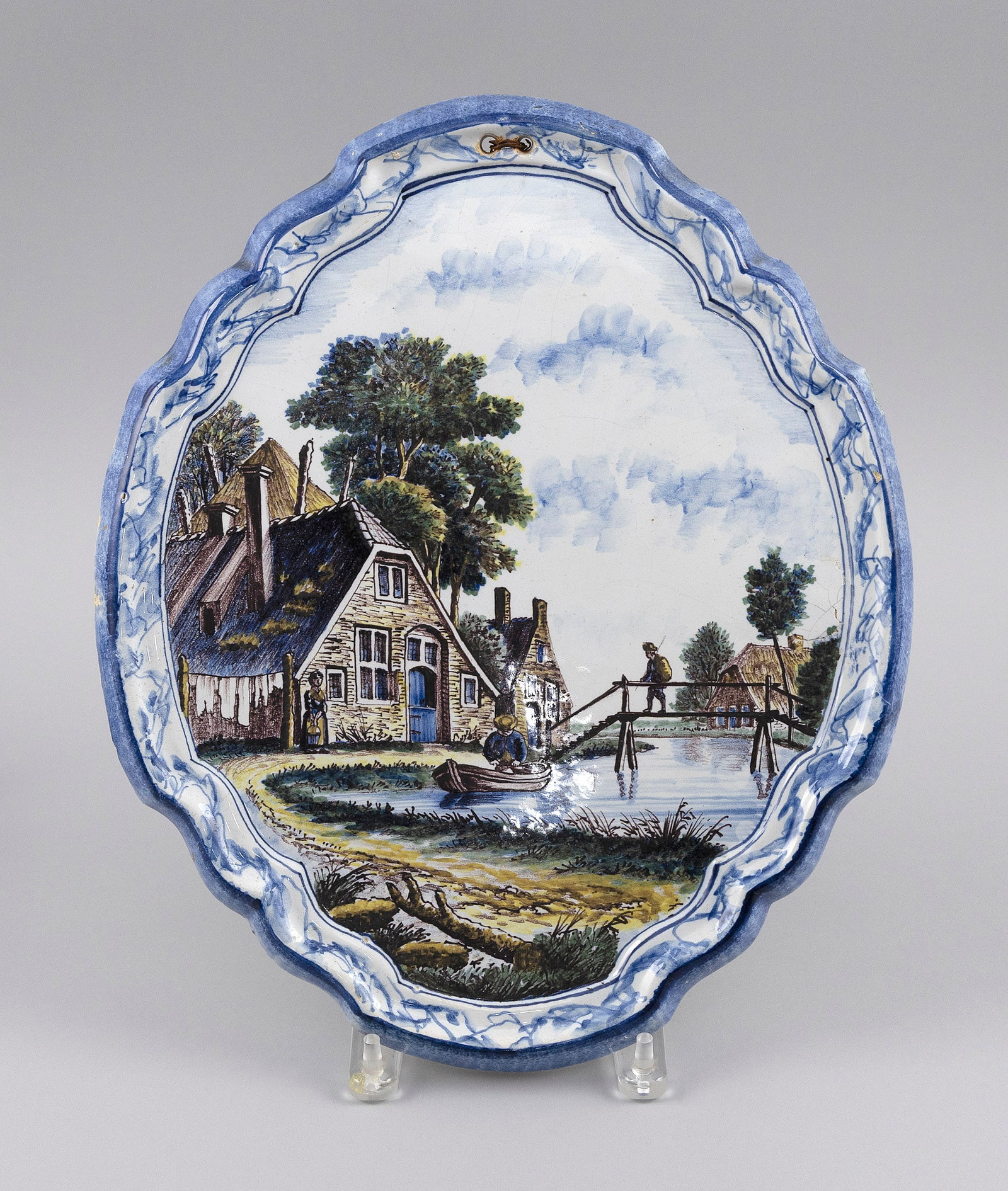 DELFT POLYCHROME PLAQUE The Netherlands, 19th Century 15.5" x 12.75".: DELFT POLYCHROME PLAQUE The Netherlands, 19th Century Depicts a bridge, a fisherman and a house by a pond. Marked "FH" on base. 15.5" x 12.75". Provenance: The Estate of Paul and Diane Madden, Sandwic