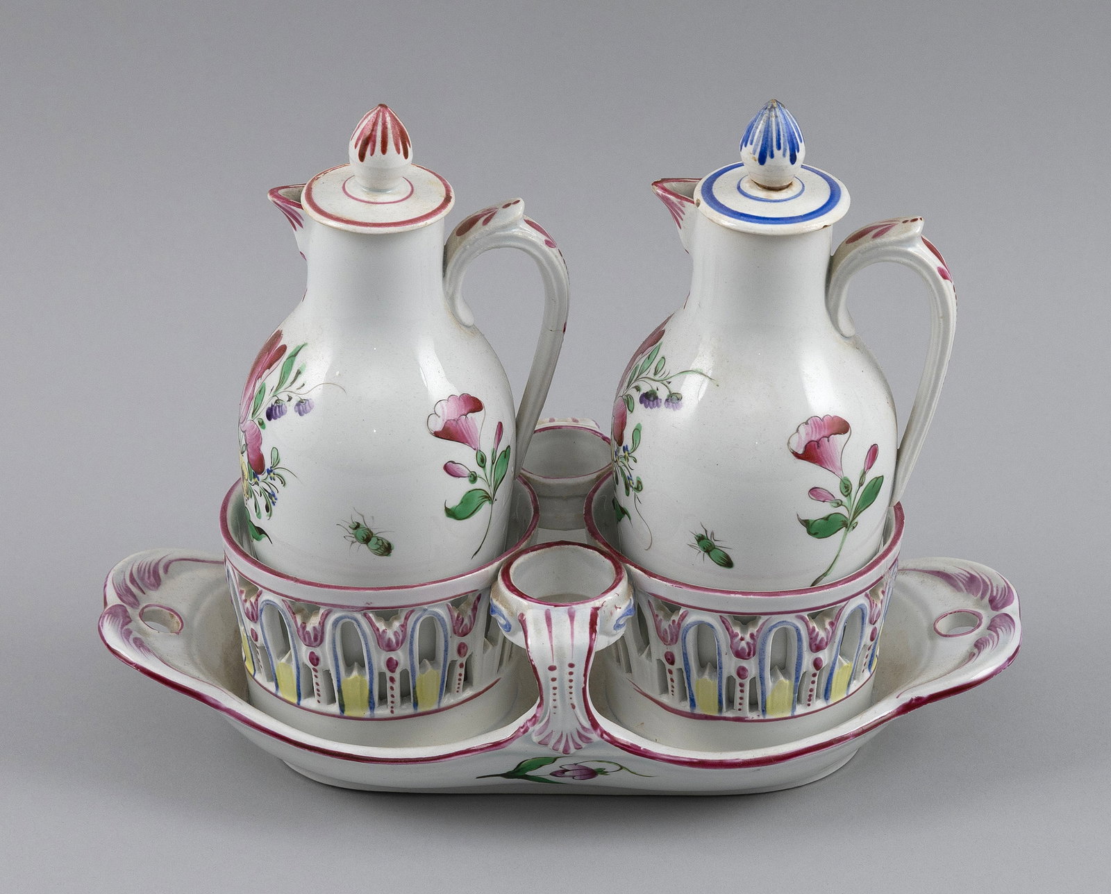 ENGLISH SOFT-PASTE VINAIGRETTE SET 19th Century Height 7.75".: ENGLISH SOFT-PASTE VINAIGRETTE SET 19th Century Includes two cruets and a stand. Floral decoration. Height 7.75". Provenance: The Estate of Paul and Diane Madden, Sandwich, Massachusetts.