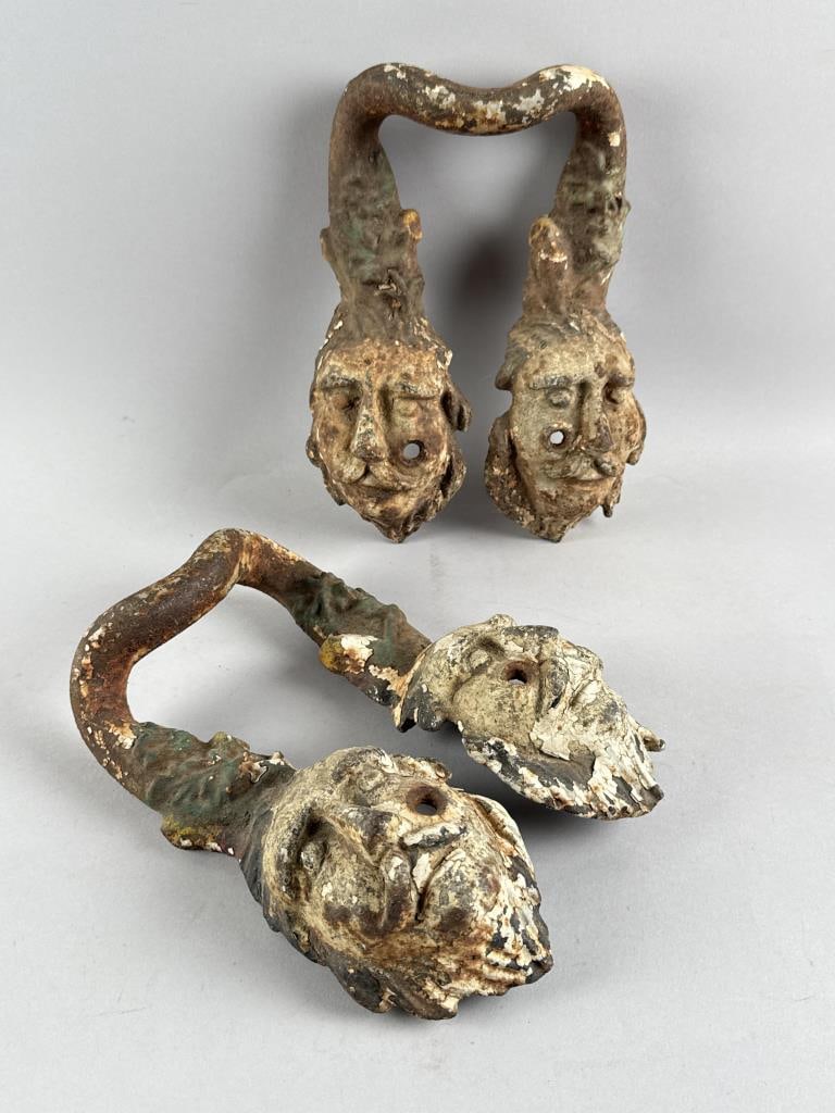 PAIR OF CAST IRON URN HANDLES 19th Century Heights 11". Widths 9". Depths 3".: PAIR OF CAST IRON URN HANDLES 19th Century Formed as leaves above the faces of mustached and bearded men. Heights 11". Widths 9". Depths 3".