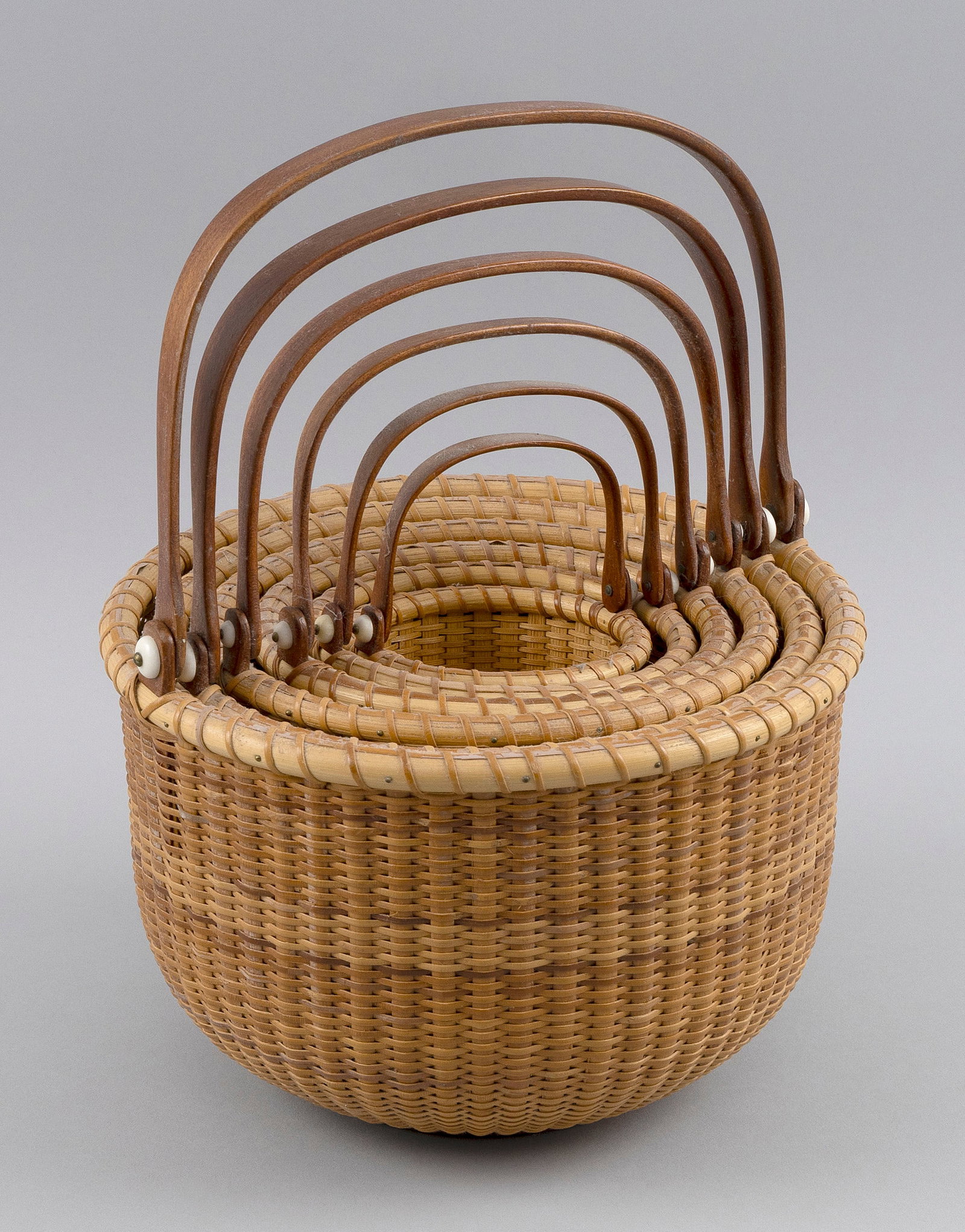 NEST OF SIX MARTHA WETHERBEE NANTUCKET BASKETS New Hampshire, Dated 1997, Heights to 5.75".: NEST OF SIX MARTHA WETHERBEE NANTUCKET BASKETS New Hampshire, Dated 1997 Base of each with an inset disc depicting a squirrel. Signed and dated on undersides. Heights to 5.75". Diameters from 3.5" to 