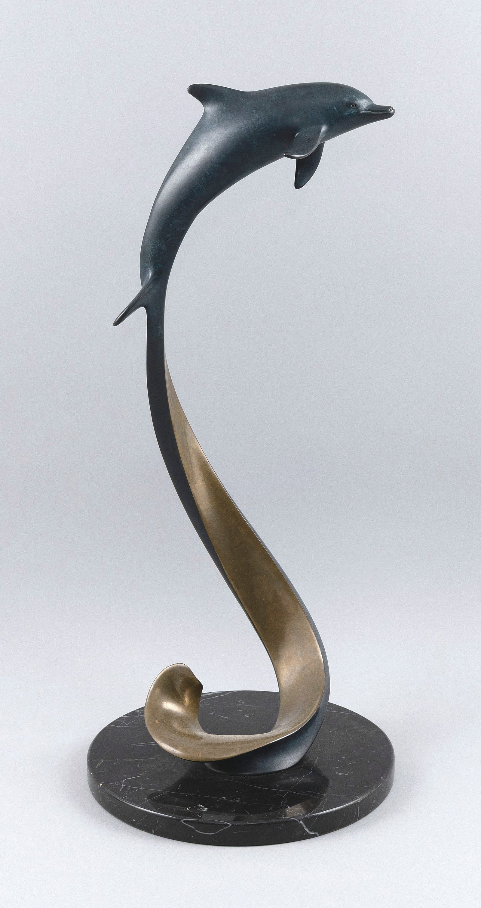 DOUG WYLIE (California, 1952-), "Surface to Air", Height 22". Base diameter 10".: DOUG WYLIE California, 1952- "Surface to Air", a bronze dolphin on a cobalt blue and black variegated marble base. Numbered 187/450. Height 22". Base diameter 10".