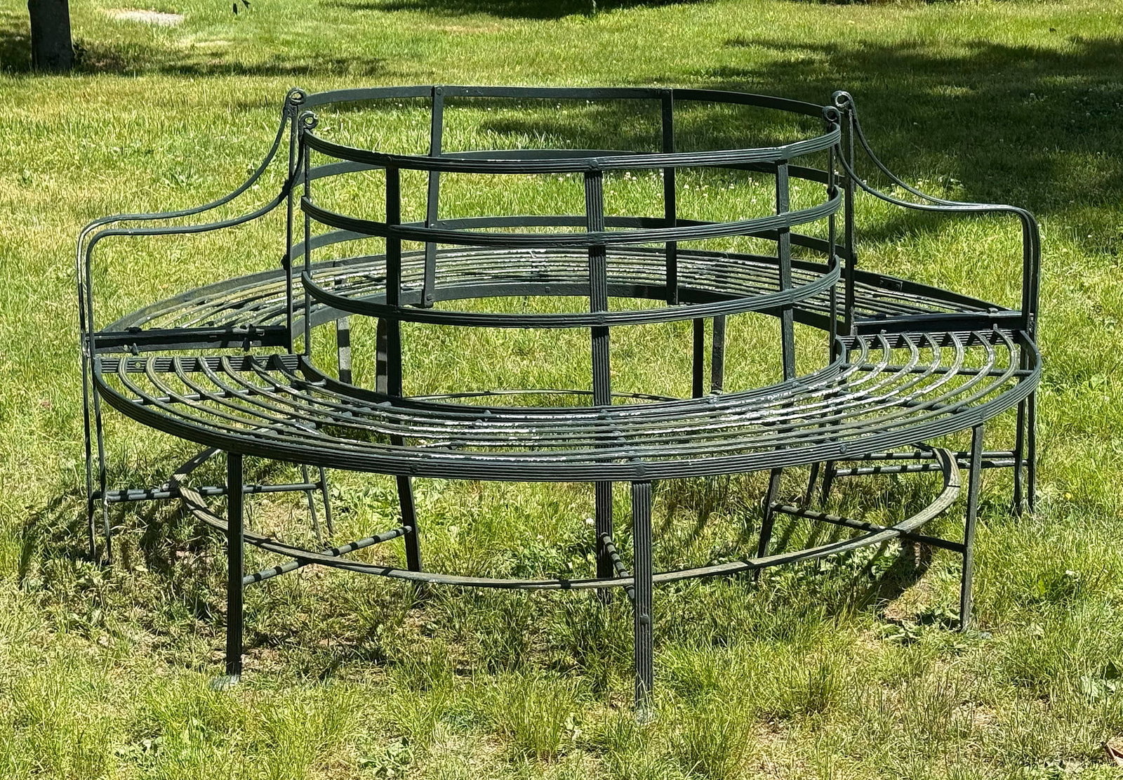 PAIR OF WROUGHT IRON WRAPAROUND TREE BENCHES 20th Century Heights 37". Lengths 80". Depths 36". (1 of 3)