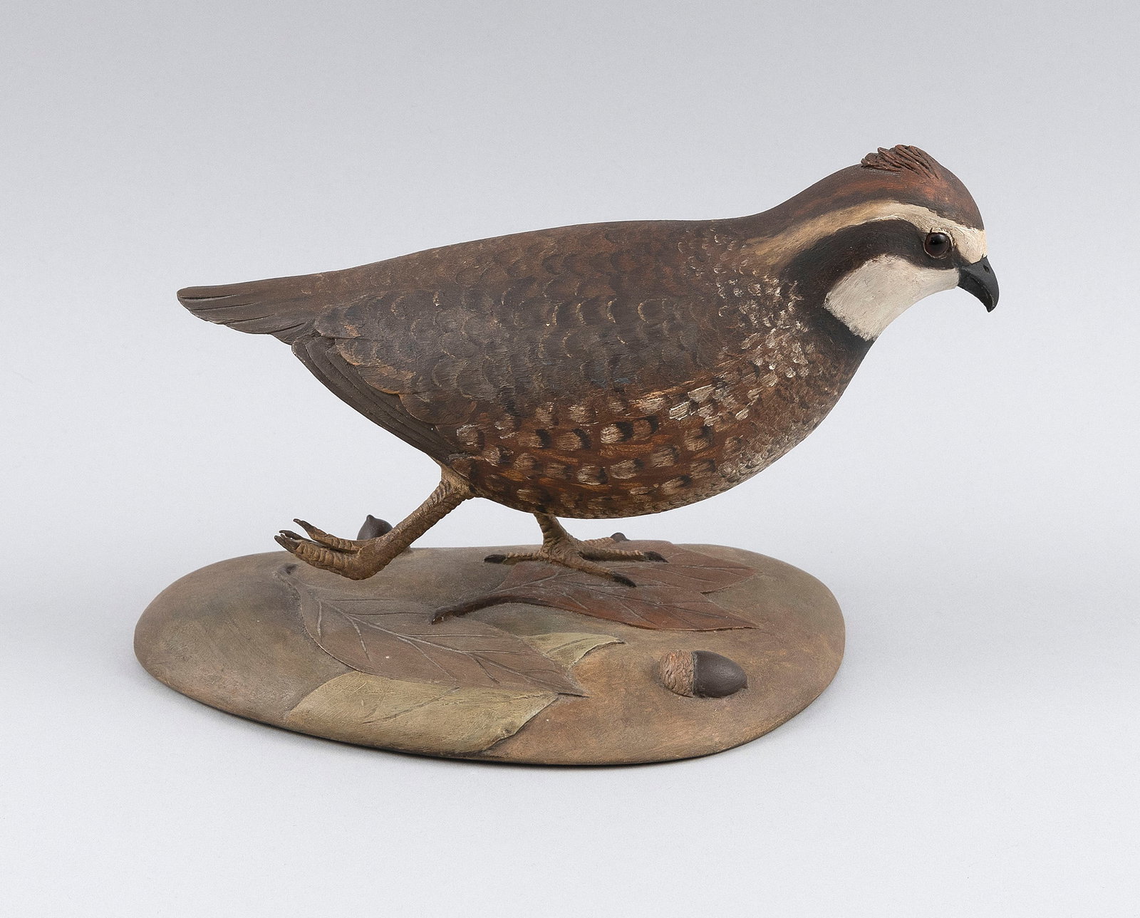 FRANK FINNEY LIFE-SIZE BOBWHITE QUAIL CARVING Capeville, Virginia, 1947- Length 9".: FRANK FINNEY LIFE-SIZE BOBWHITE QUAIL CARVING Capeville, Virginia, 1947- In running form on a rockery base. Signed with carved "F" on underside of base. Length 9".