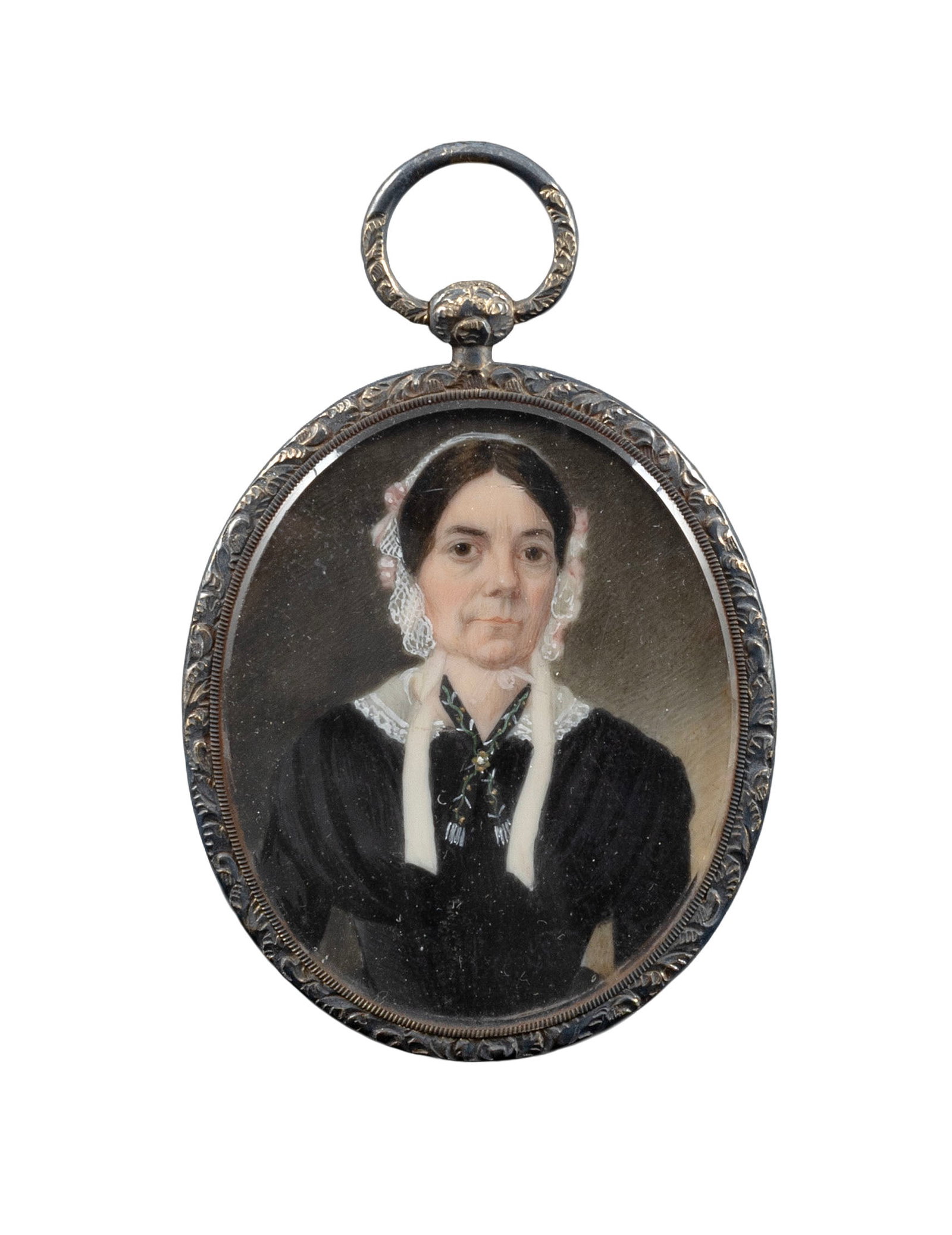 AMERICAN SCHOOL (19th Century,), Portrait miniature on ivory of a mature woman, Watercolor, 2" x: AMERICAN SCHOOL 19th Century Portrait miniature on ivory of a mature woman wearing a white lace cap with pink ribbons, a lace collar, a black dress and a vine-patterned fichu around her neck secured w