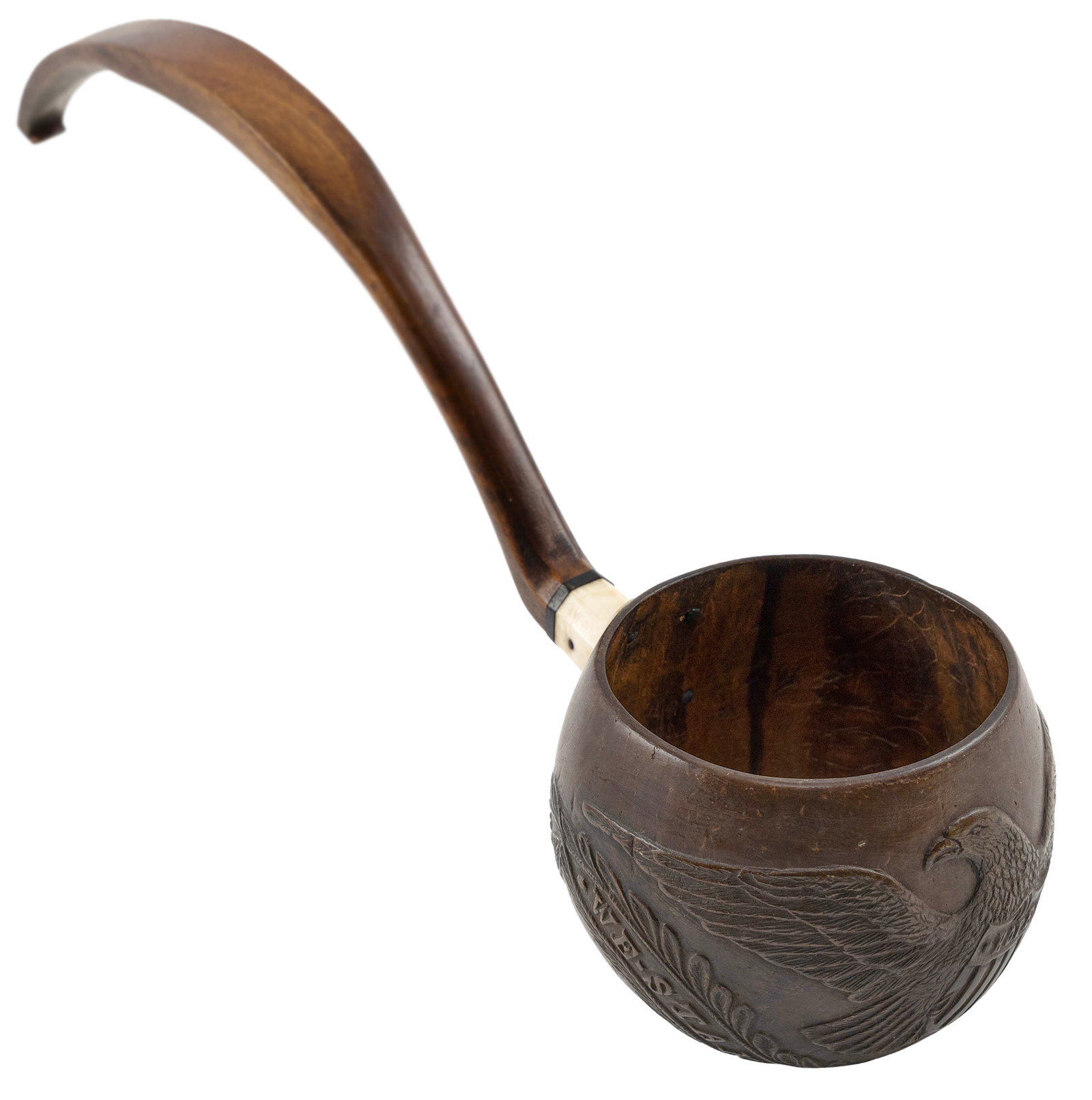 CARVED COCONUT SHELL DIPPER WITH PATRIOTIC MOTIFS America, Circa 1860 Length 14.5". With stand.: CARVED COCONUT SHELL DIPPER WITH PATRIOTIC MOTIFS America, Circa 1860 Depicts a spread-wing eagle clutching a "Hope" shield, a "United We Stand Divided We Fall" ribband, leaf garlands and a stem of ro