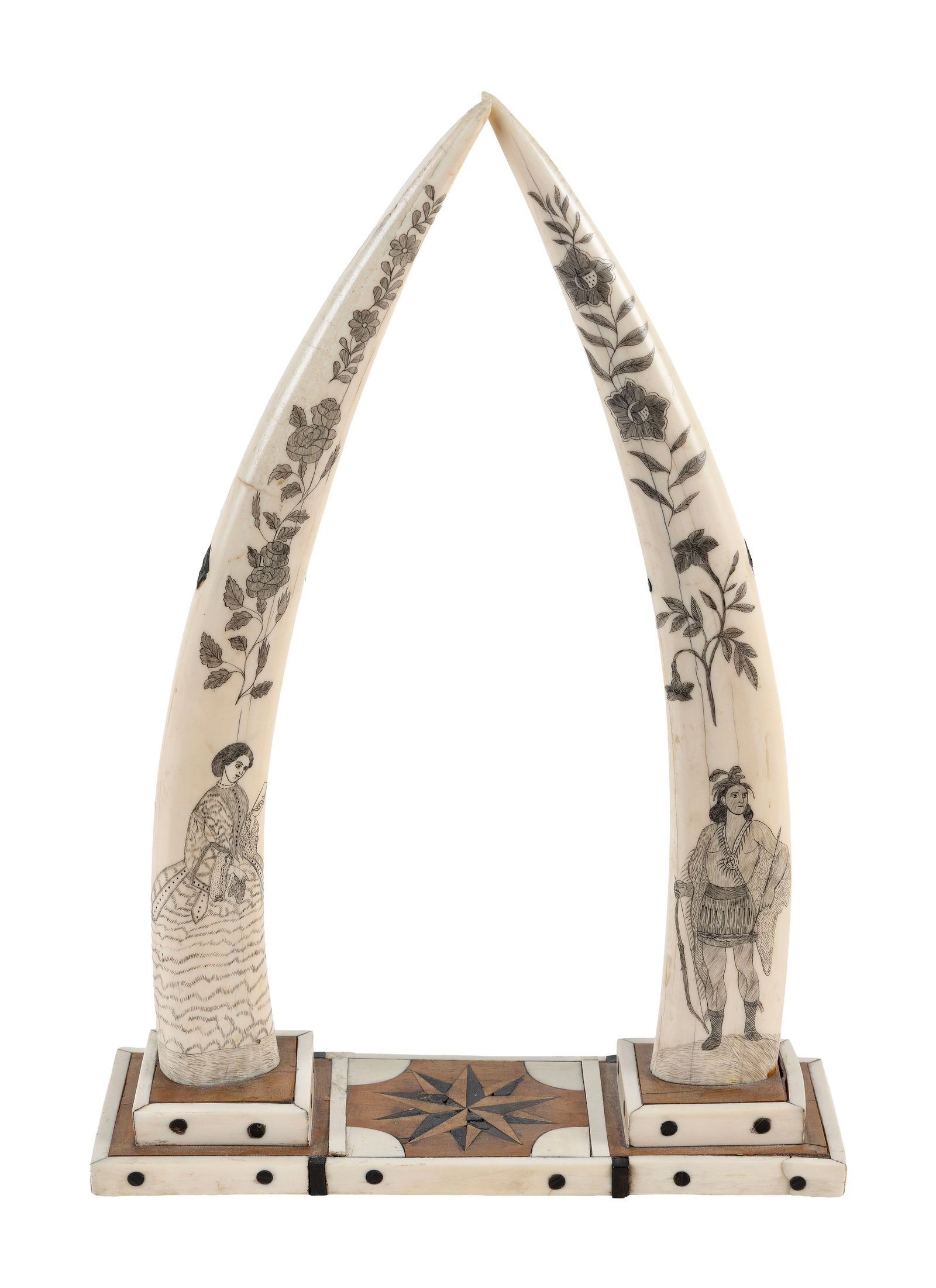 FINE PAIR OF SCRIMSHAW WALRUS TUSKS America, Mid-19th Century Height 17.75". Base width 12.25".: FINE PAIR OF SCRIMSHAW WALRUS TUSKS America, Mid-19th Century Finely engraved with floral sprigs and standing figures, one with a woman reading a letter and the other with an American Native holding a