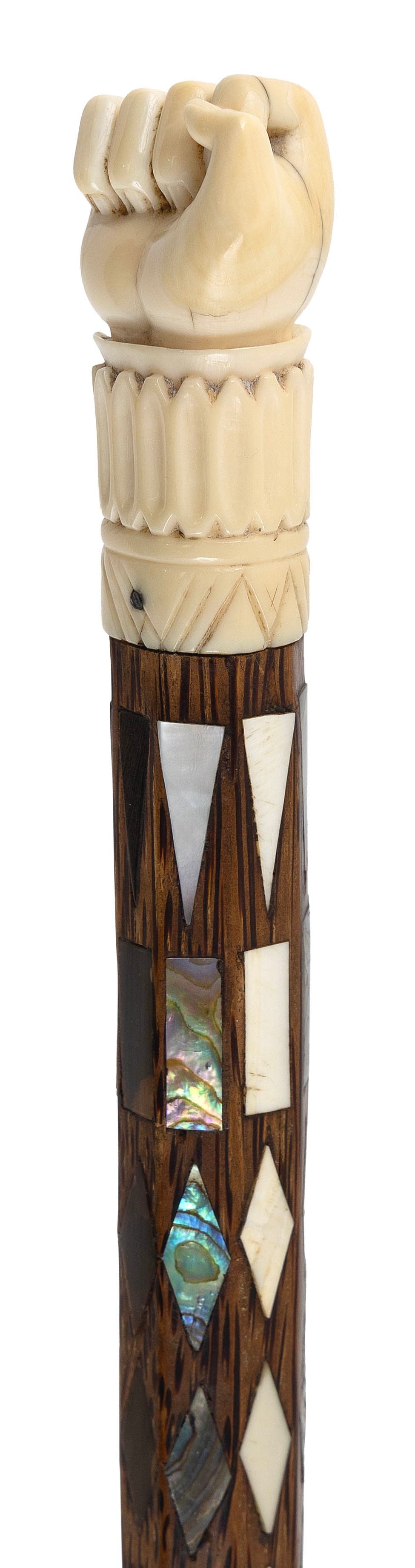 SCRIMSHAW CLENCHED FIST WALKING STICK Early 19th Century Length 37.25".: SCRIMSHAW CLENCHED FIST WALKING STICK Early 19th Century Whale ivory handle carved as a clenched right fist and ruffled cuff. Octagonal tropical wood shaft tapers to a cylinder, the upper portion inla