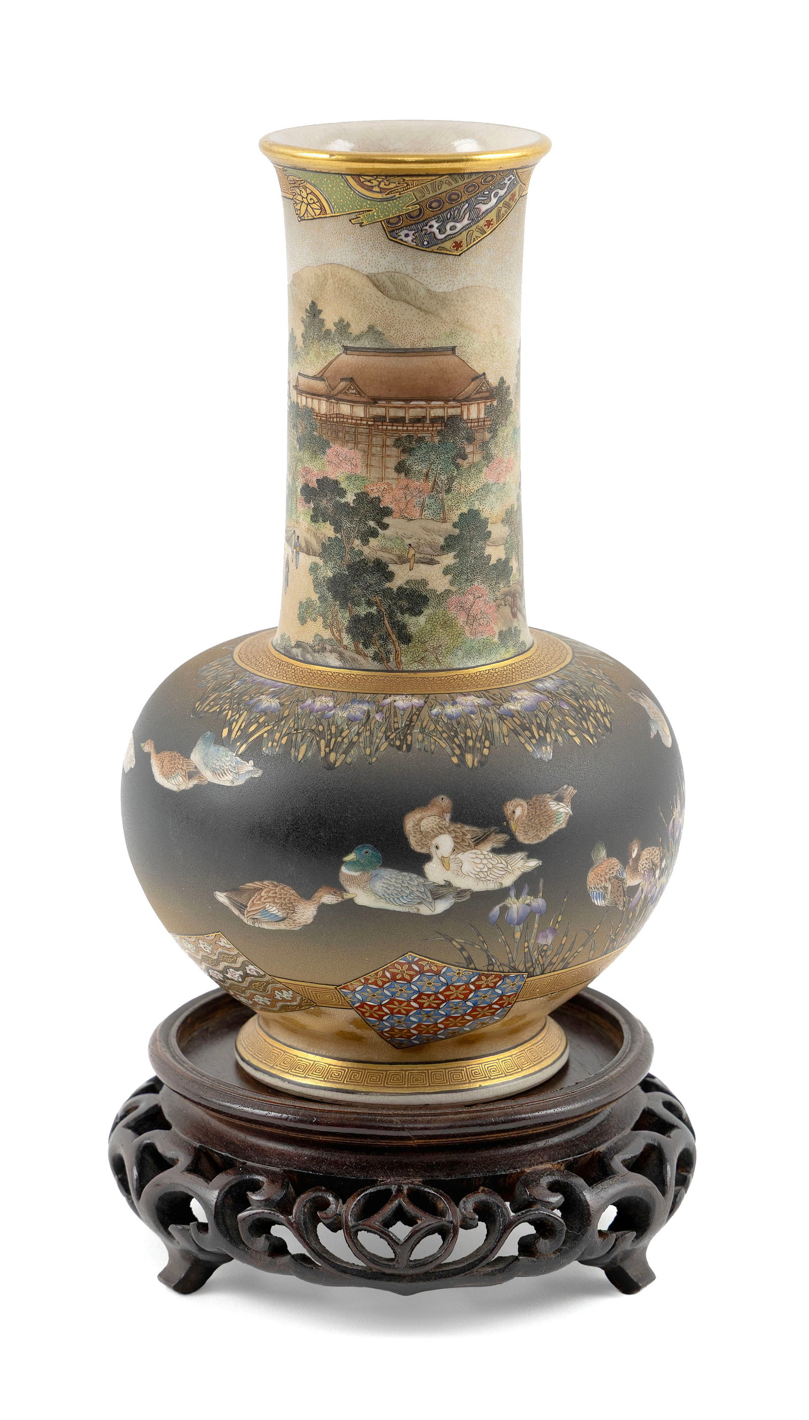 JAPANESE SATSUMA PORCELAIN VASE Meiji Period Height 7.5". With carved wood stand.: JAPANESE SATSUMA PORCELAIN VASE Meiji Period Cylindrical neck with decoration of figures walking toward a temple, highlighted in gilt. Bulbous base with finely painted decoration of ducks and iris aga