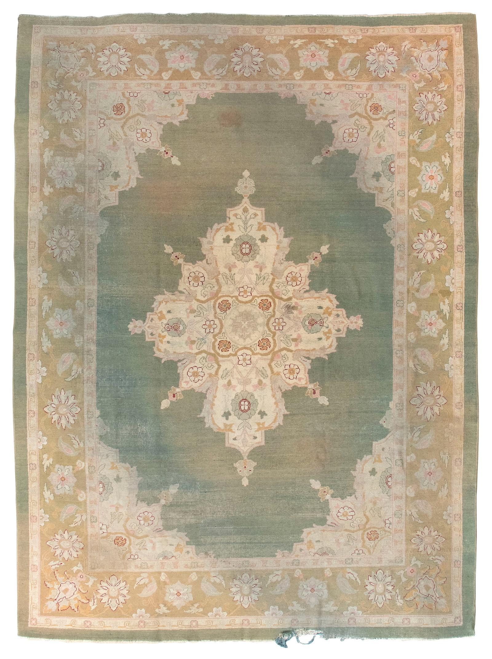 AGRA RUG: 9'1" X 12'6" Second Quarter of the 20th Century: AGRA RUG: 9'1" X 12'6" Second Quarter of the 20th Century An ivory quatrefoil medallion with olive green, celadon green, pastel pink and deep scarlet red motifs occupies the center of an empty lawn gr