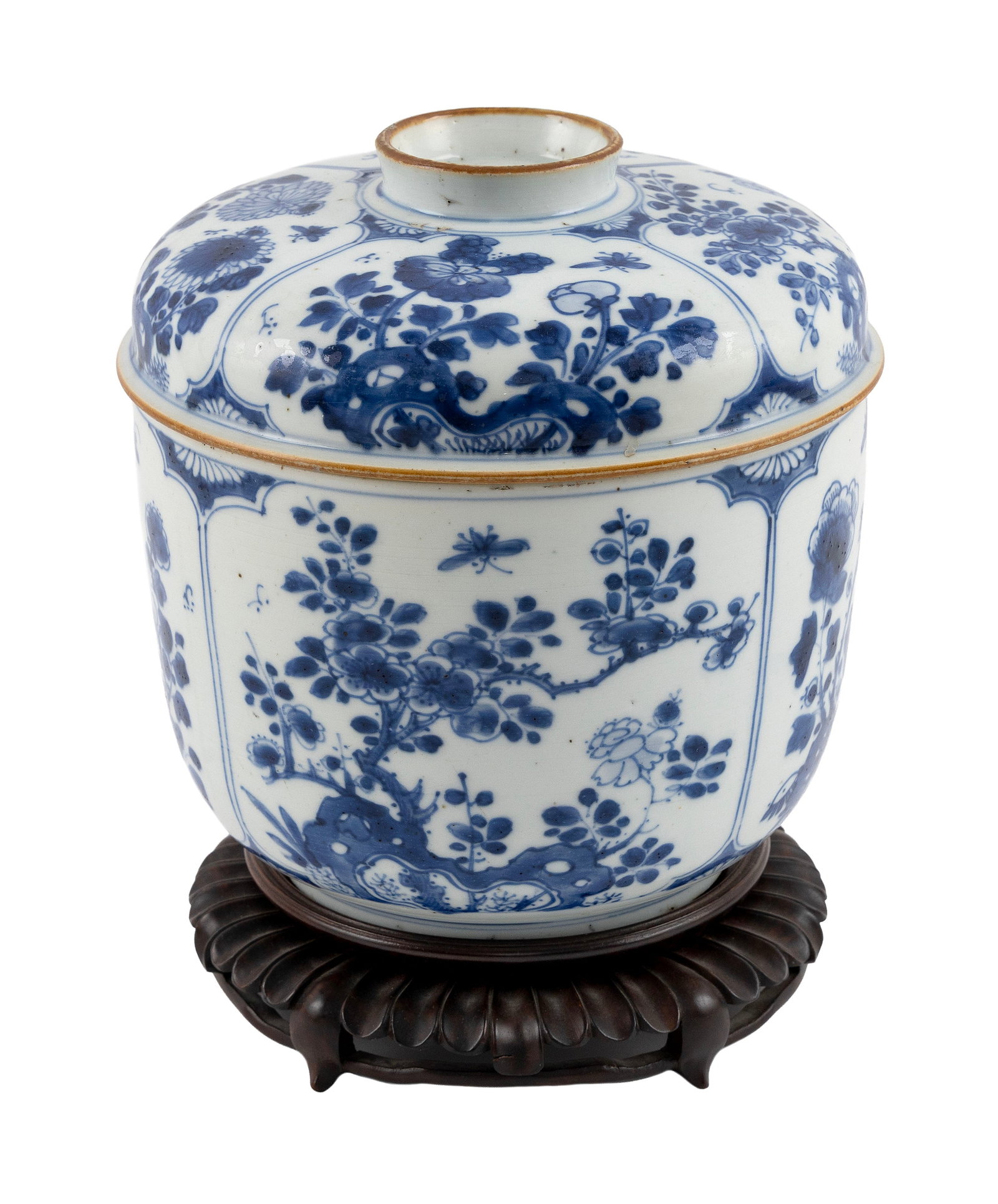 CHINESE EXPORT BLUE AND WHITE PORCELAIN COVERED BOWL Kangxi Period, Circa 1700 Height 9". Diameter: CHINESE EXPORT BLUE AND WHITE PORCELAIN COVERED BOWL Kangxi Period, Circa 1700 Decoration of floral vignettes about the body. Domed cover. Height 9". Diameter 8.25". With carved wooden stand. Provenan