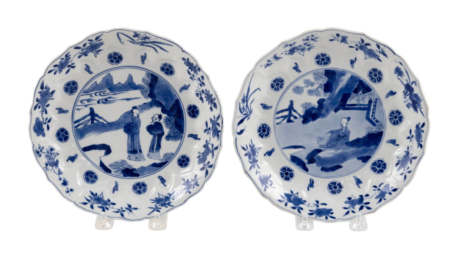 PAIR OF CHINESE BLUE AND WHITE PORCELAIN LOTUS PLATES Kangxi Period, Circa 1700 Diameters 8".: PAIR OF CHINESE BLUE AND WHITE PORCELAIN LOTUS PLATES Kangxi Period, Circa 1700 Central figural decoration surrounded by floral borders. Six-character Kangxi mark on bases. Diameters 8". Provenance: P