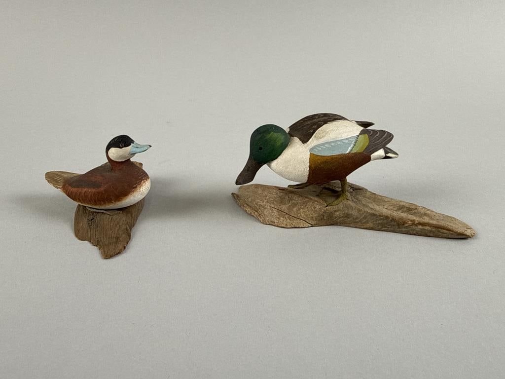 TWO HAROLD GIBBS MINIATURE BIRD CARVINGS Barrington, Rhode Island, 1866-1970 Heights 1.75" and 2".: TWO HAROLD GIBBS MINIATURE BIRD CARVINGS Barrington, Rhode Island, 1866-1970 Circa 1960. A ruddy duck drake and a shoveler, both mounted on driftwood bases. Heights 1.75" and 2".