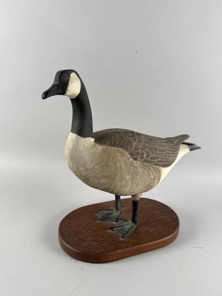 CANADA GOOSE CARVING 20th Century Height 12". Length 12".: CANADA GOOSE CARVING 20th Century On an oblong wooden base. Signed "Donaldson" or "Davidson" on base. According to the consignor, the carver was from Harwich, Massachusetts. Height 12". Length 12".