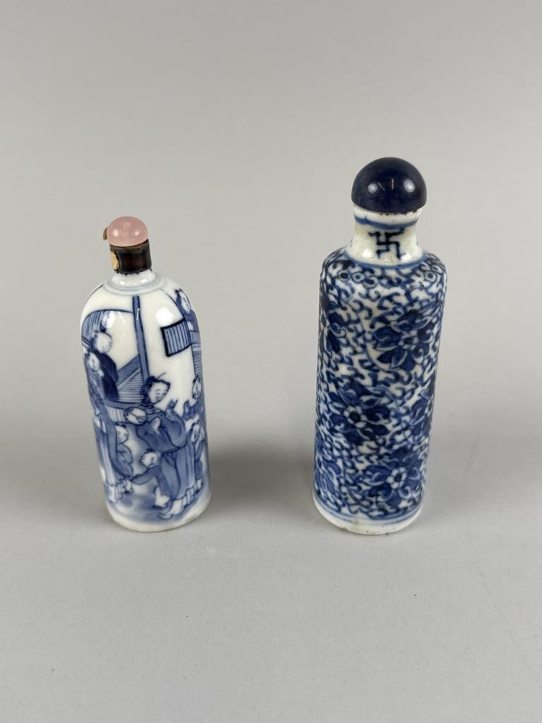 TWO CHINESE BLUE AND WHITE PORCELAIN SNUFF BOTTLES 19th Century: TWO CHINESE BLUE AND WHITE PORCELAIN SNUFF BOTTLES 19th Century 1) Figural decoration. Unmarked. Height 3.25". 2) Floral decoration. Six-character Qianlong mark. Height 3.75". Both with stoppers.