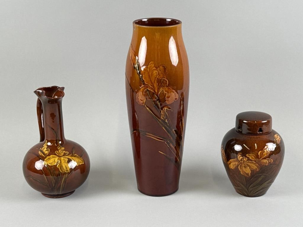 THREE PIECES OF ROOKWOOD POTTERY Cincinnati, Late 19th Century: THREE PIECES OF ROOKWOOD POTTERY Cincinnati, Late 19th Century All with maker's mark on underside. 1) Pitcher with iris decoration. Height 7.5". Length 4.75". Width 4.5". 2) Matthew A. Daly for Rookwo