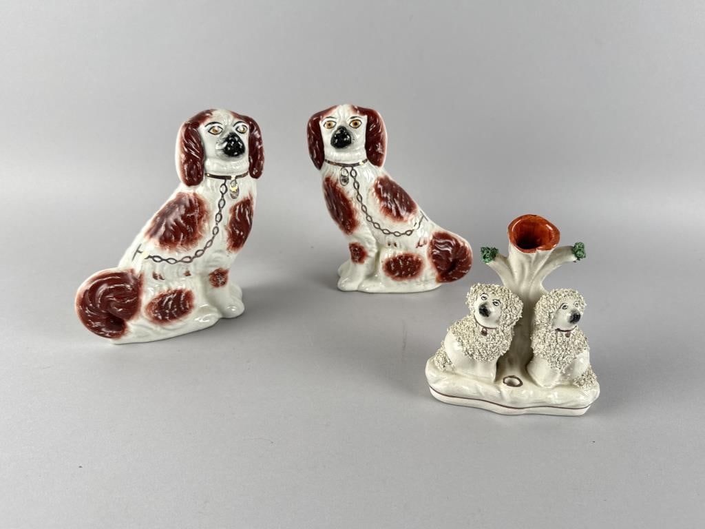 THREE PIECES OF STAFFORDSHIRE 19th Century: THREE PIECES OF STAFFORDSHIRE 19th Century 1-2) Pair of red and white spaniels with gilt collars. Heights 7". 3) Spill vase and pen holder formed as two poodles flanking a tree trunk. Gilt trim. Heigh
