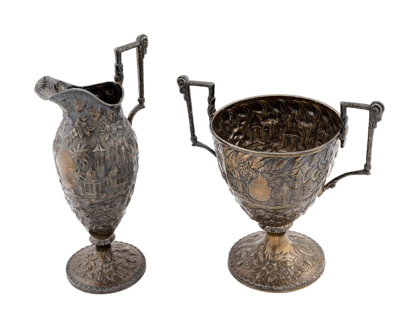 TWO PIECES OF SAMUEL KIRK "ETRUSCAN CASTLE" COIN SILVER Baltimore, Circa 1830 Approx. 34.2 troy oz.: TWO PIECES OF SAMUEL KIRK "ETRUSCAN CASTLE" COIN SILVER Baltimore, Circa 1830 A loving cup and a ewer, both with ram's-head handles. Produced before Samuel's son joined the firm. Both marked "Sam. Kir