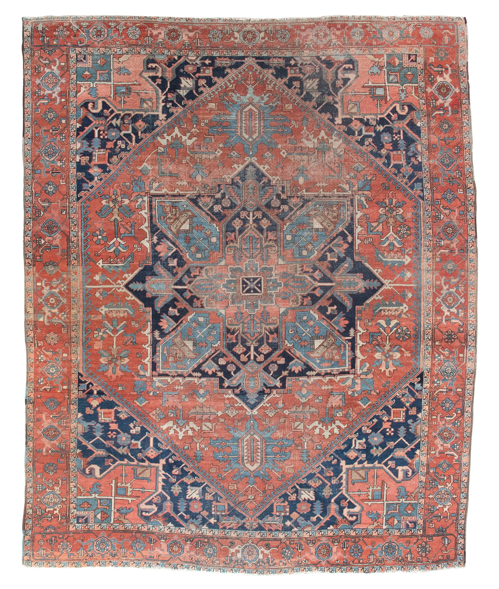 HERIZ RUG: 9'3" X 11'6" First Quarter of the 20th Century: HERIZ RUG: 9'3" X 11'6" First Quarter of the 20th Century Traditional navy and marine blue gabled medallion suspends abrashed marine blue pendants on a terracotta field. Stylized vines bear blossoms a