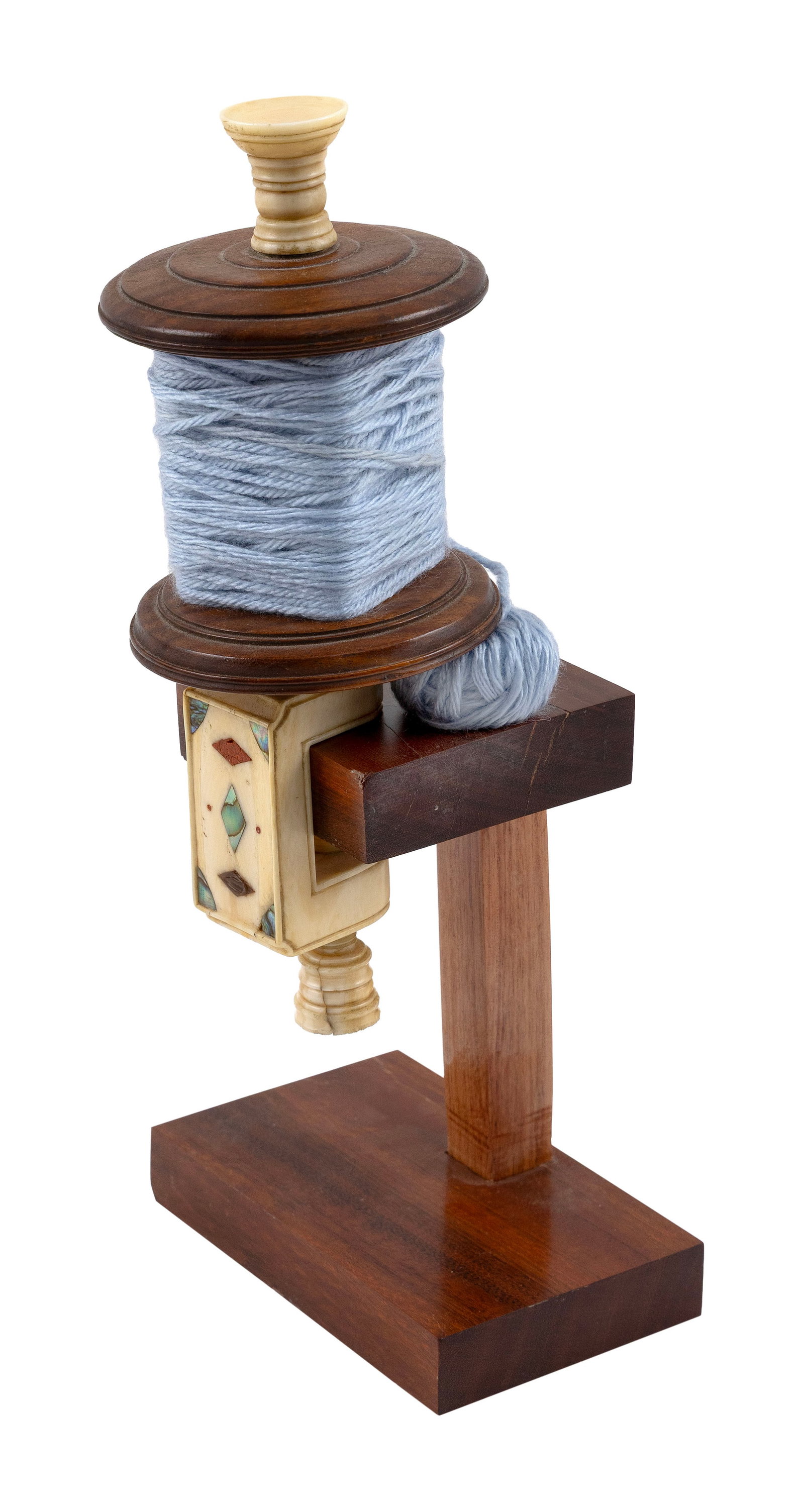 WHALE IVORY AND WOOD YARN WINDER Mid-19th Century Length 8".: WHALE IVORY AND WOOD YARN WINDER Mid-19th Century Carved whale ivory yarn cup, supports, clamp and tightening screw. Clamp with inlaid mother-of-pearl and red sealing wax diamonds and triangles. Lengt