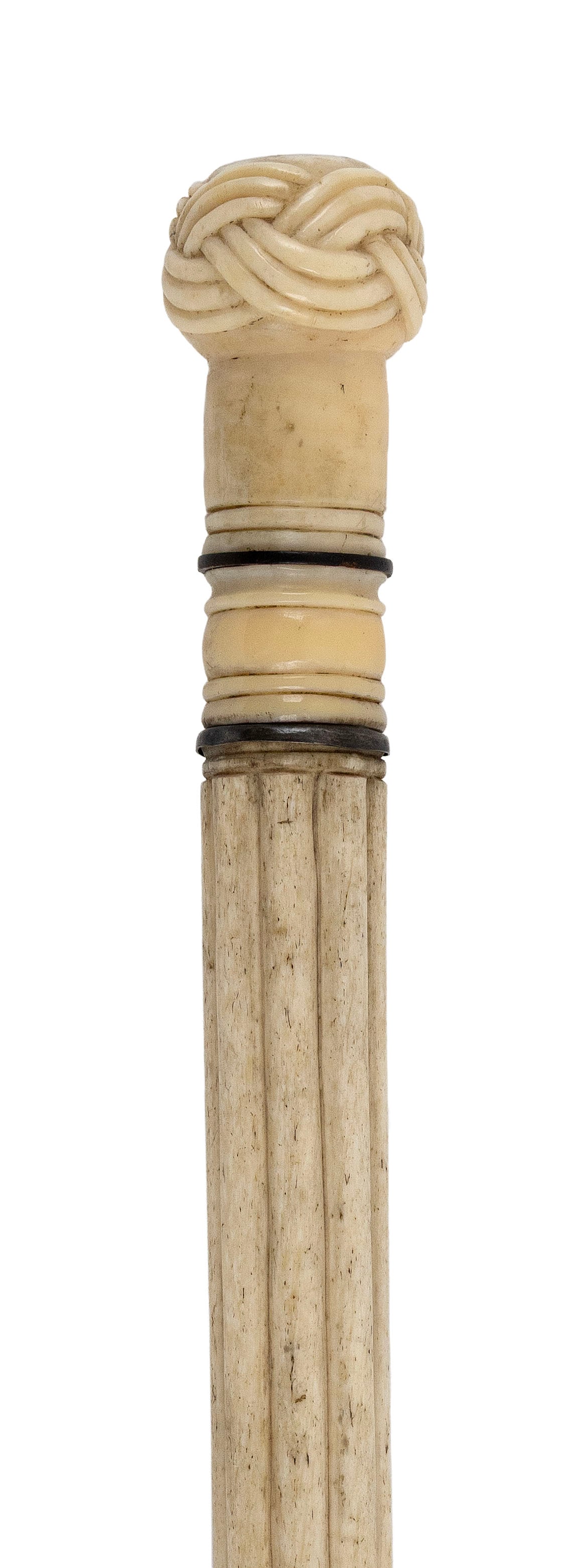 EXTENSIVELY CARVED WHALE IVORY AND WHALEBONE CANE Mid-19th Century Length 34.5".: EXTENSIVELY CARVED WHALE IVORY AND WHALEBONE CANE Mid-19th Century Whale ivory Turk's-head knot handle inlaid with a mother-of-pearl disk. Ring-turned throat with contrasting spacers, one apparently b
