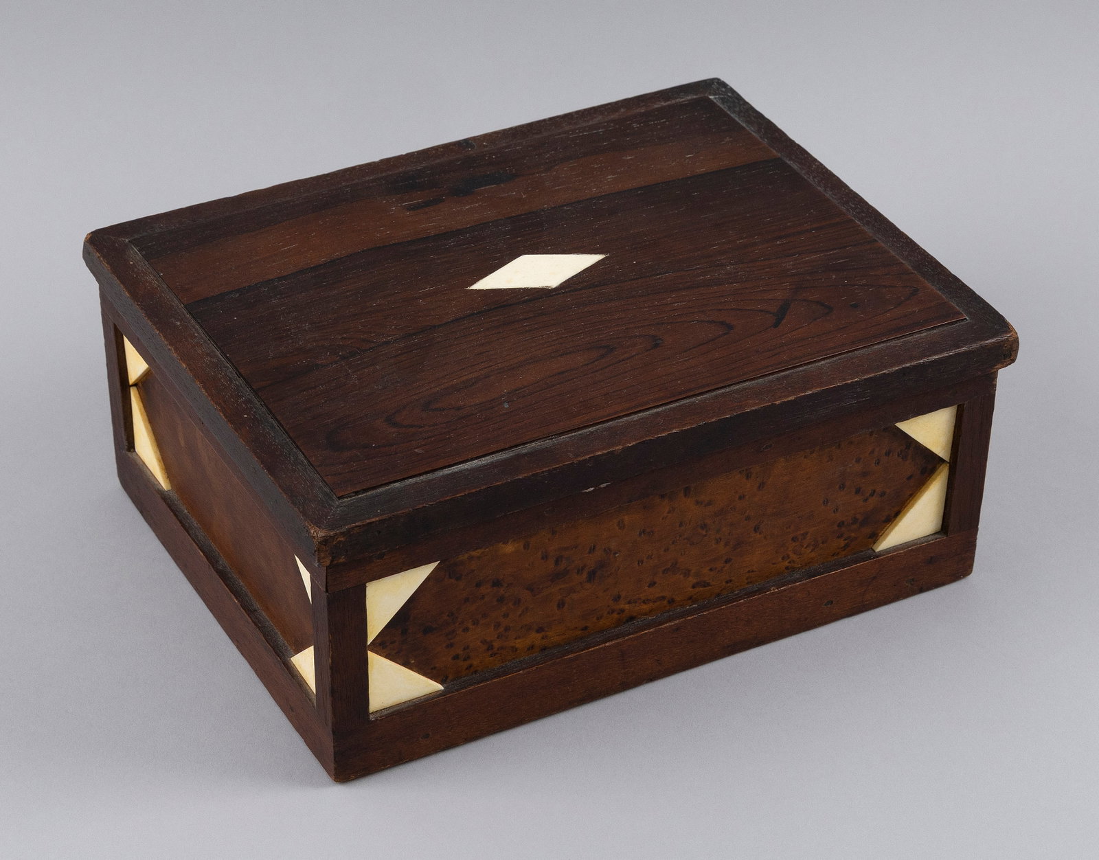 SAILOR-MADE ROSEWOOD AND WHALEBONE BOX 19th Century Height 4.25". Width 10.25". Depth 7.5".: SAILOR-MADE ROSEWOOD AND WHALEBONE BOX 19th Century Lid with an inlaid whalebone diamond at center. Front with applied whalebone triangles at each corner. Height 4.25". Width 10.25". Depth 7.5".