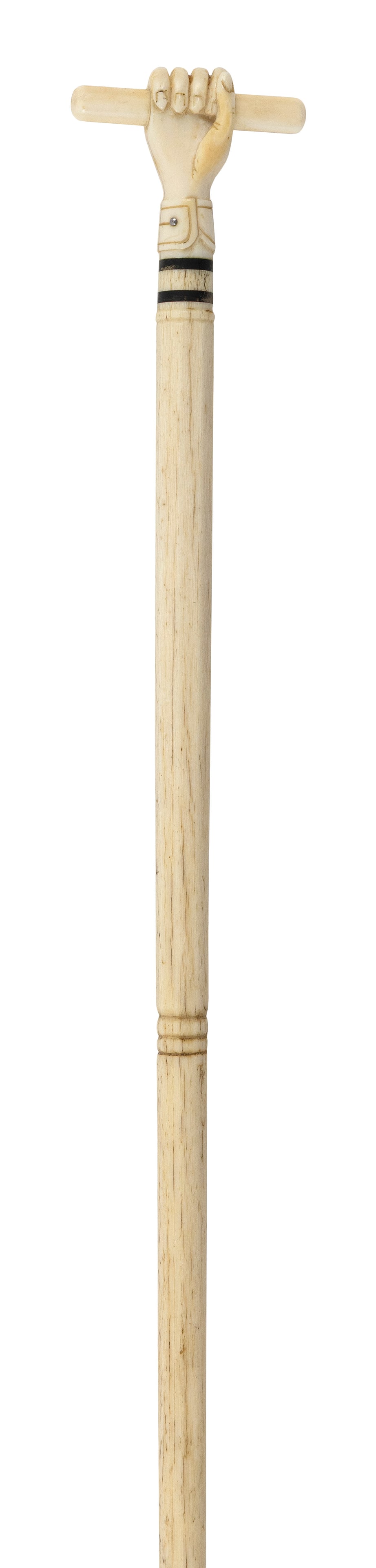 LADY'S CLENCHED FIST CANE 19th Century Length 34.75".: LADY'S CLENCHED FIST CANE 19th Century Beautifully carved diminutive whale ivory handle carved in the form of a clenched fist holding a baton, with a folded cuff and a single button. Whalebone shaft. 