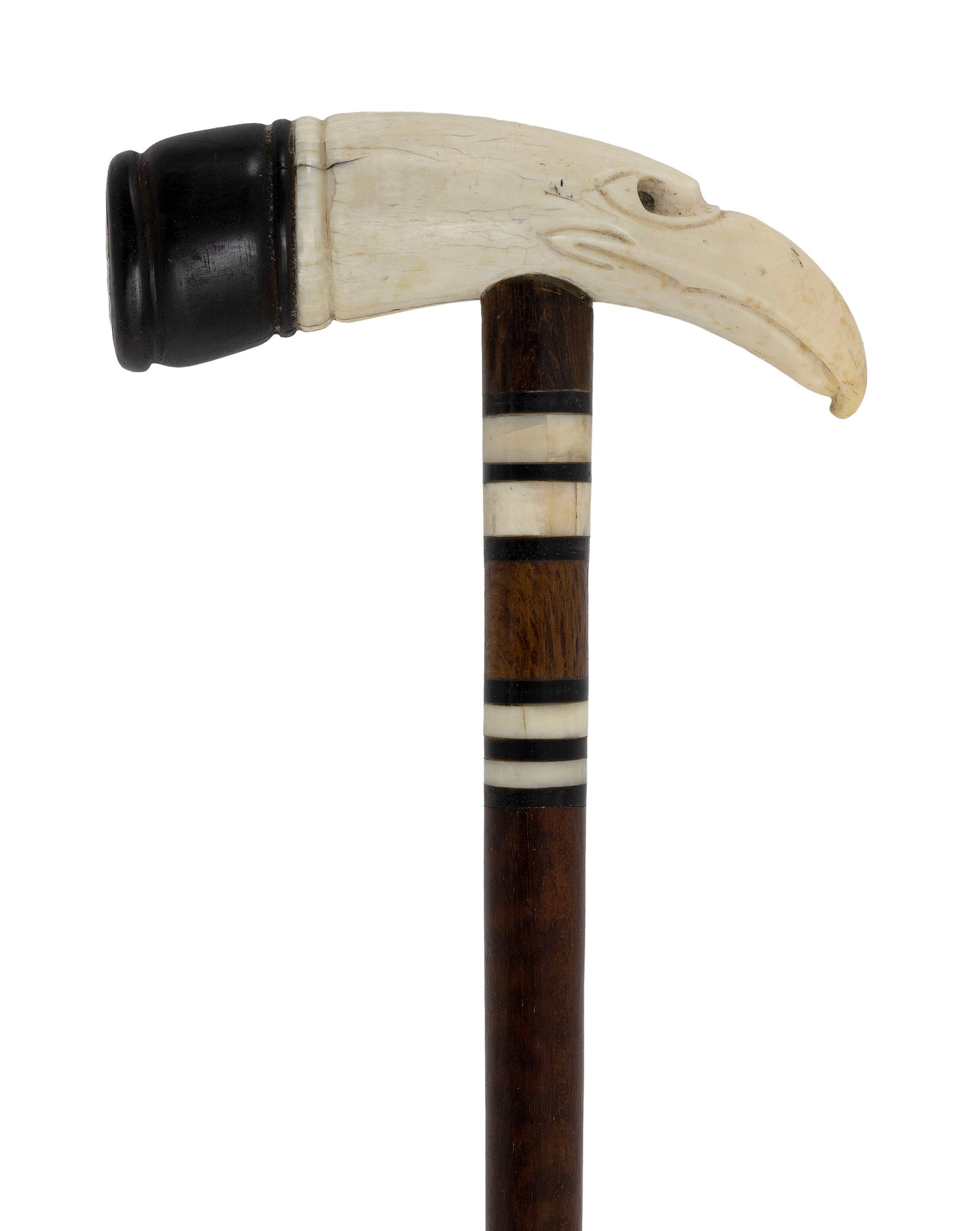 EAGLE'S HEAD CANE 19th Century Length 36.75".: EAGLE'S HEAD CANE 19th Century Whale ivory handle carved as an eagle's head with deeply inset eyes and a long beak. Wood cap at end of handle with vivid mother-of-pearl or abalone inlay. Throat with w
