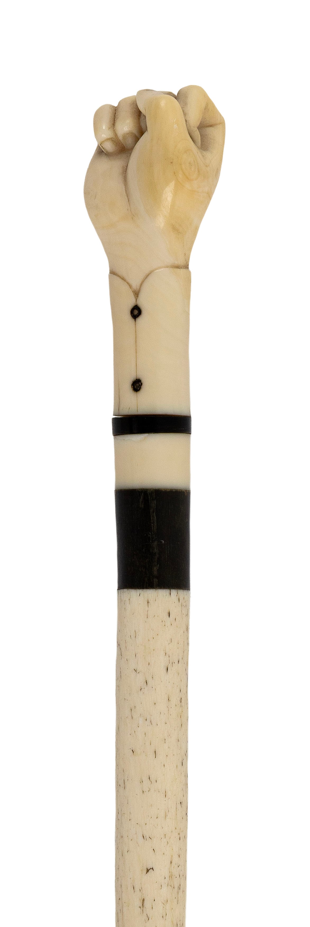FINE CLENCHED FIST CANE 19th Century Length 33.75".: FINE CLENCHED FIST CANE 19th Century Beautifully carved whale ivory handle with detailed cuff and inlaid buttons. Throat with baleen and brass banding. Whalebone shaft with brass ferrule. Length 33.75