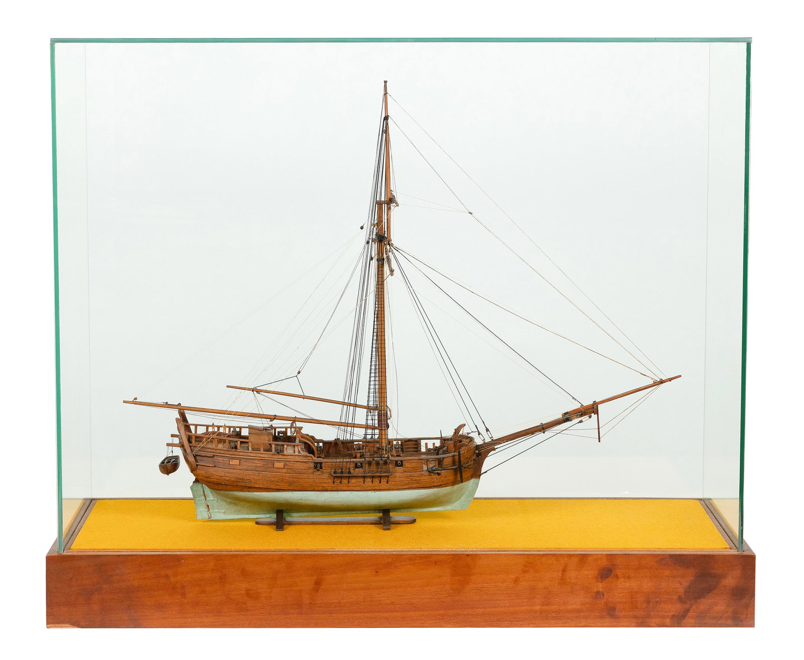 CASED MODEL OF THE GAFF-RIGGED VESSEL "PROVIDENCE", IN THE MANNER OF WILLIAM E. HITCHCOCK Early 20th: CASED MODEL OF THE GAFF-RIGGED VESSEL "PROVIDENCE", IN THE MANNER OF WILLIAM E. HITCHCOCK Early 20th Century Displayed on a cradle within a glass and wood case. Case height 31". Length 37.75". Width 1