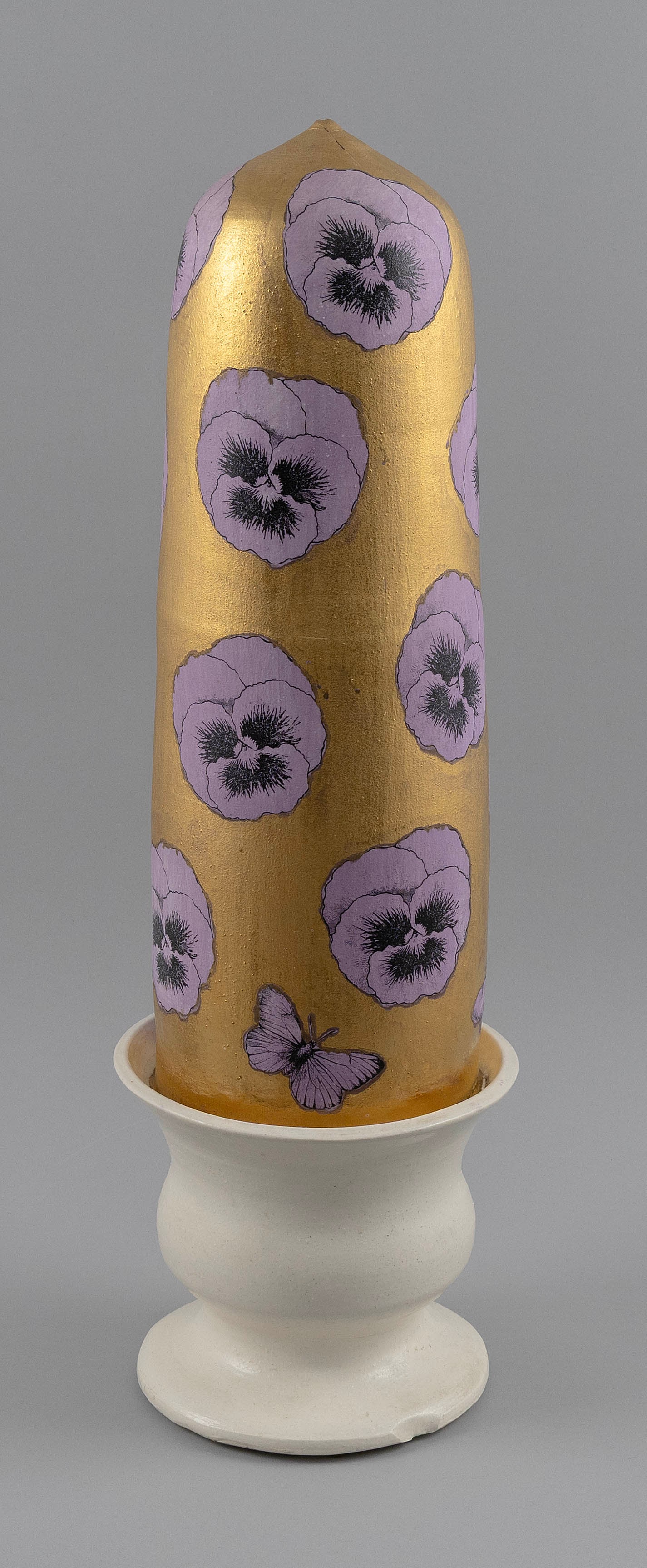 TOM MCCANNA (New York/Massachusetts, Contemporary), Gilt and painted ceramic wig stand, Height: TOM MCCANNA New York/Massachusetts, Contemporary Gilt and painted ceramic wig stand with decoration of purple pansies and butterflies against a gilt ground and a white glaze urn-form base. Stamped sig