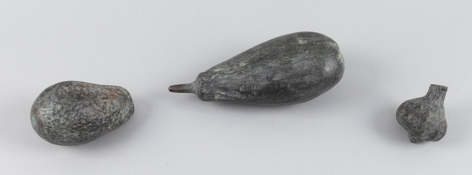THREE PIECES OF PATINATED BRONZE VEGETABLES Lengths 3", 4.5" and 8". (1 of 2)