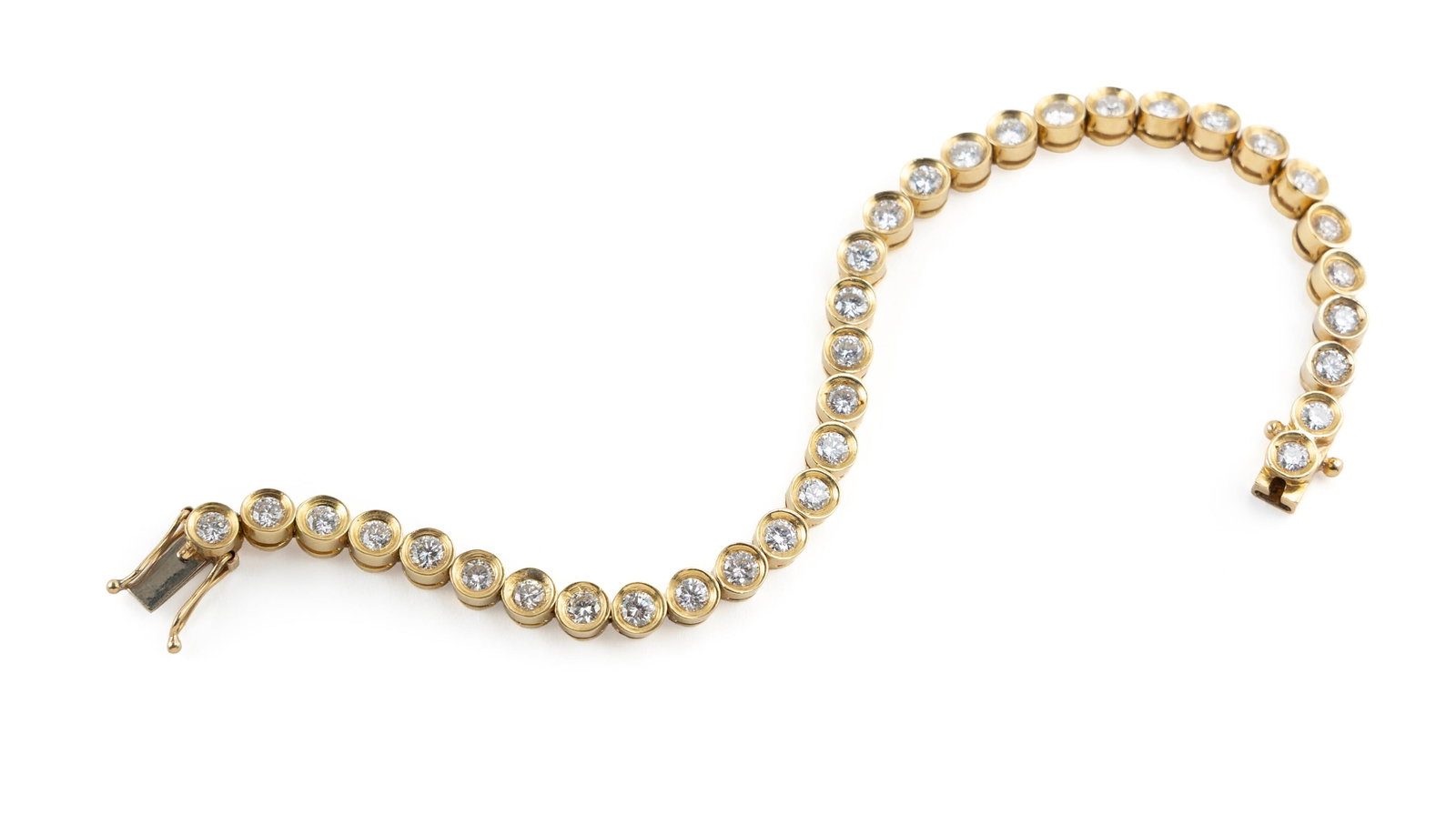 18KT YELLOW GOLD DIAMOND TENNIS BRACELET Approx. 11.7 total dwt.: 18KT YELLOW GOLD DIAMOND TENNIS BRACELET Thirty-four bezel-set round-cut diamonds, approx. 3.50 ctw. Box clasp with double fold-over safety. Stamped. Length 6.5". Approx. 11.7 total dwt.