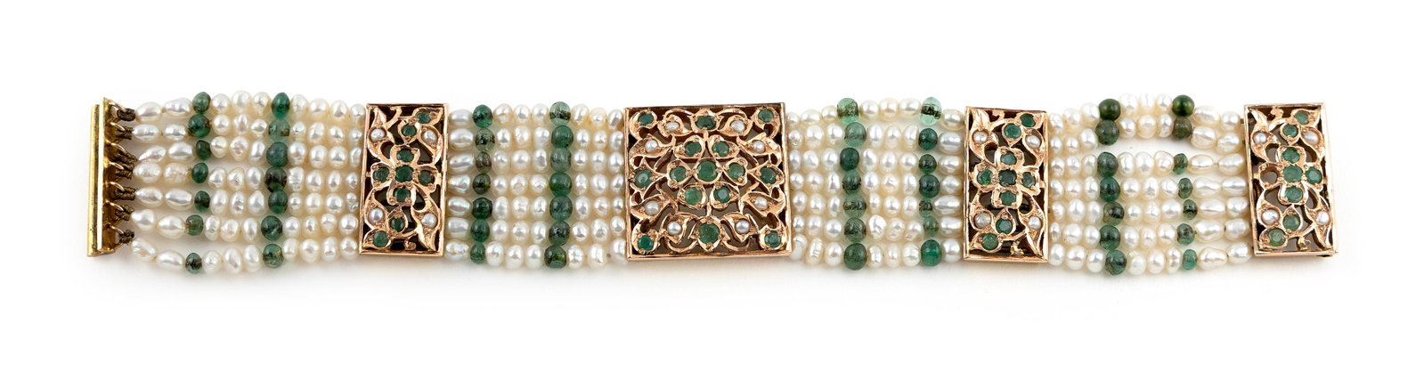14KT YELLOW GOLD, CULTURED PEARL AND EMERALD BRACELET Approx. 18.2 total dwt.: 14KT YELLOW GOLD, CULTURED PEARL AND EMERALD BRACELET Seven strands. Central approx. 22.0 x 22.0 section, two approx. 11.0 x 22.0mm spacers and an approx. 11.0 x 22.0mm slide-style clasp each with see