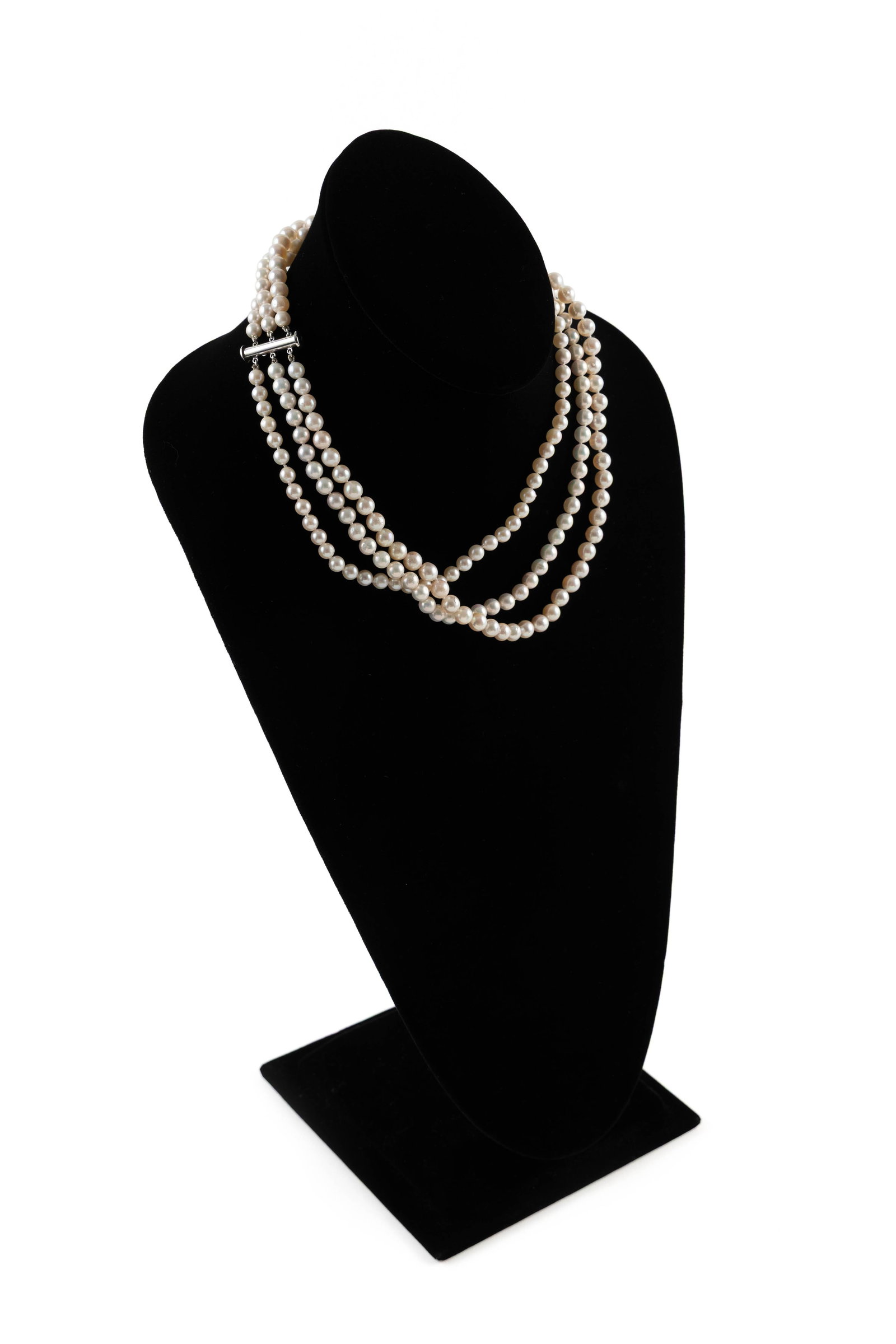 14KT WHITE GOLD AND CULTURED PEARL NECKLACE: 14KT WHITE GOLD AND CULTURED PEARL NECKLACE Three strands of graduating approx. 5.0, 5.5 and 6.0mm pearls. Slide-in barrel clasp. Stamped. Length 17".