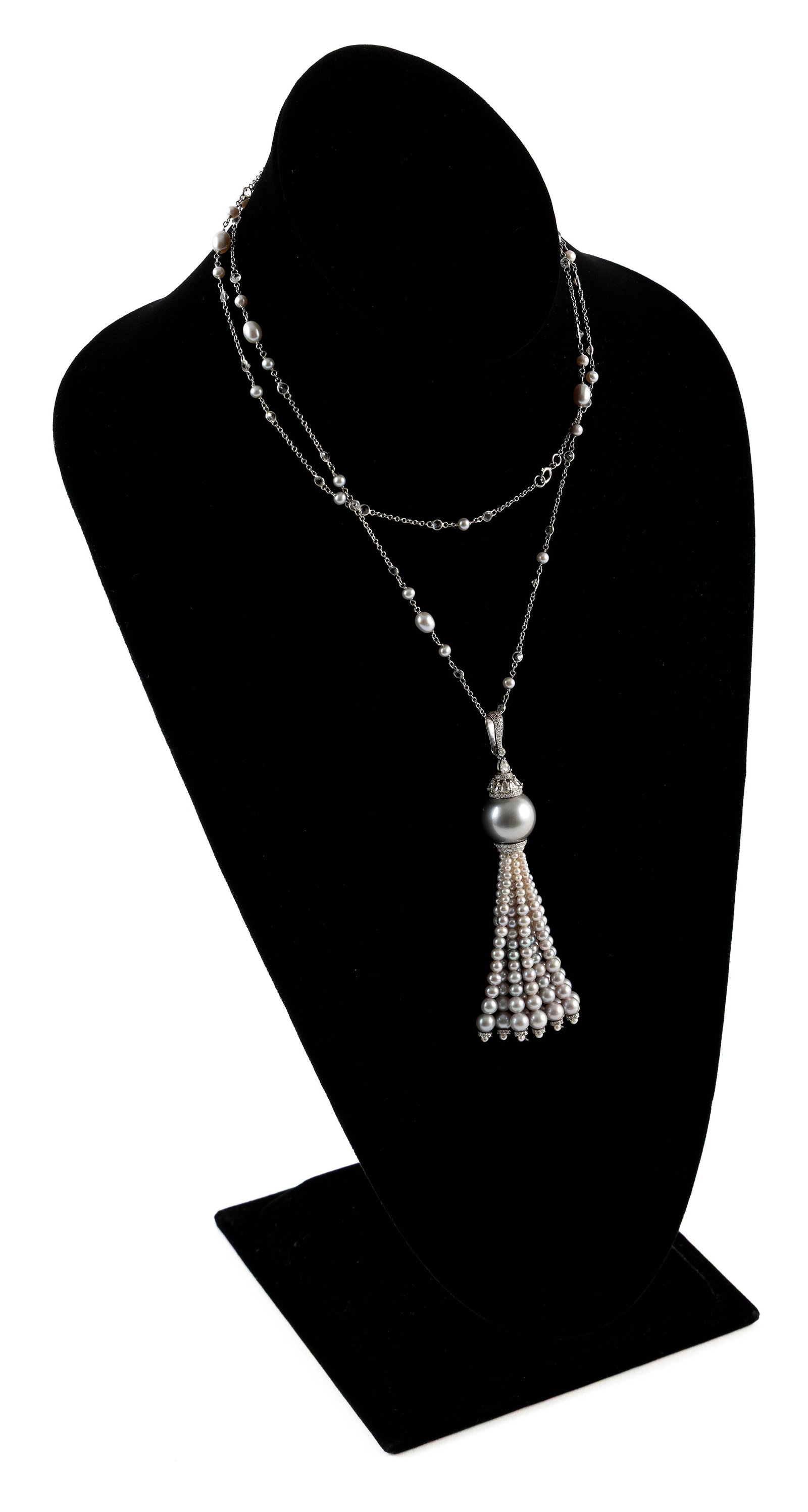 NIGAAM 18KT WHITE DIAMOND AND CULTURED GRAY PEARL NECKLACE Approx. 18.1 total dwt.: NIGAAM 18KT WHITE DIAMOND AND CULTURED GRAY PEARL NECKLACE Chain with 36 small bezel set round diamonds, approx. 2.50 ctw., and 30 small approx. 3.5 to 5.0mm gray pearls. Tasseled pendant with one app