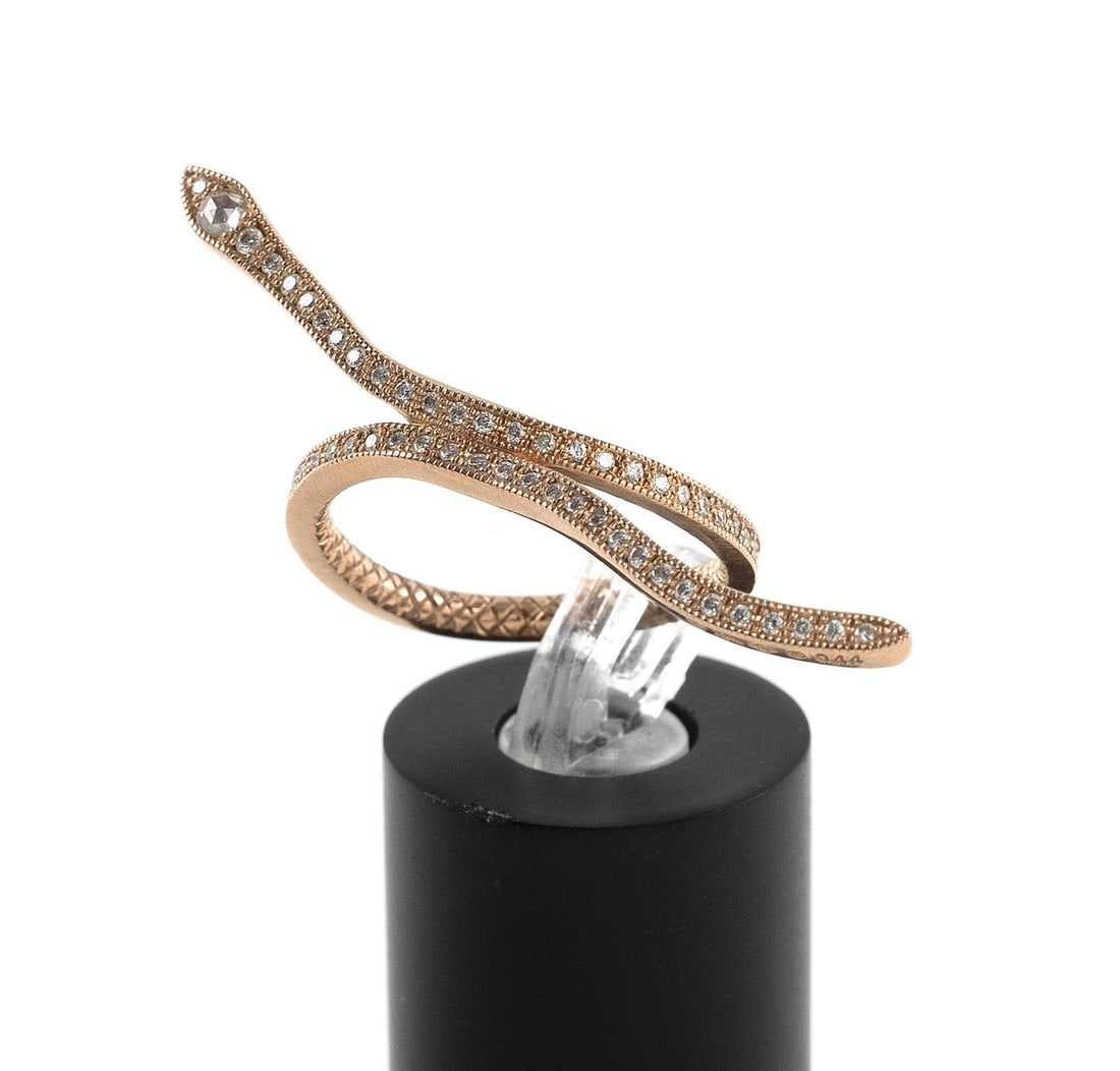14KT YELLOW GOLD AND DIAMOND SNAKE RING Approx. 3.6 total dwt.: 14KT YELLOW GOLD AND DIAMOND SNAKE RING Approx. 77 small round diamonds and one small rose cut diamond on the head. Two small round ruby eyes. Diamonds approx. 0.50 ctw. Stamped. Width approx. 2.0mm. 