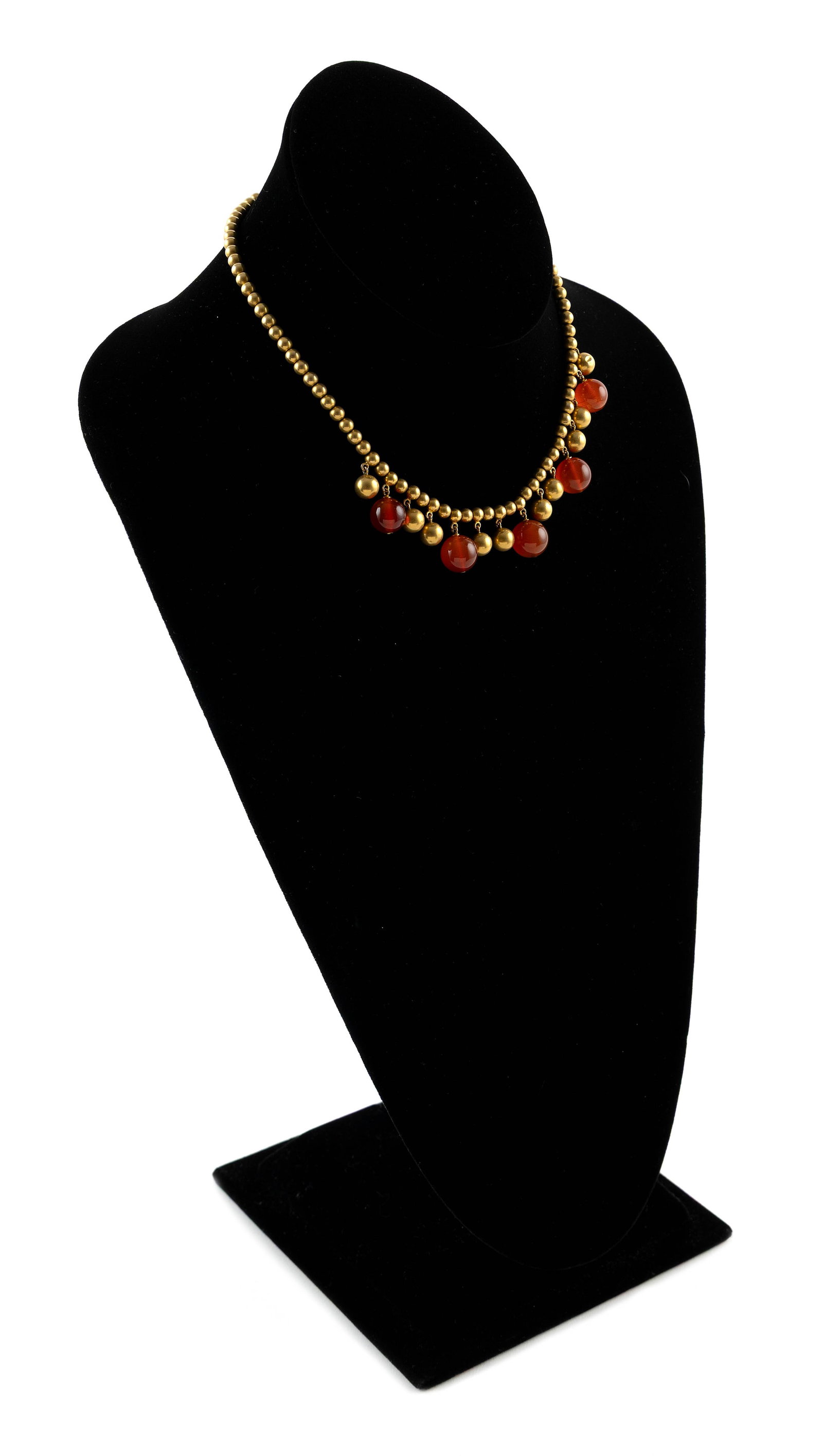 14KT YELLOW GOLD AND CARNELIAN BEAD NECKLACE Approx. 14.3 total dwt.: 14KT YELLOW GOLD AND CARNELIAN BEAD NECKLACE 14KT yellow gold necklace with approx. 4.0mm gold beads, 10 approx. 7.0mm gold beads and five approx. 10.0 to 11.0mm round carnelian beads. Box style clasp